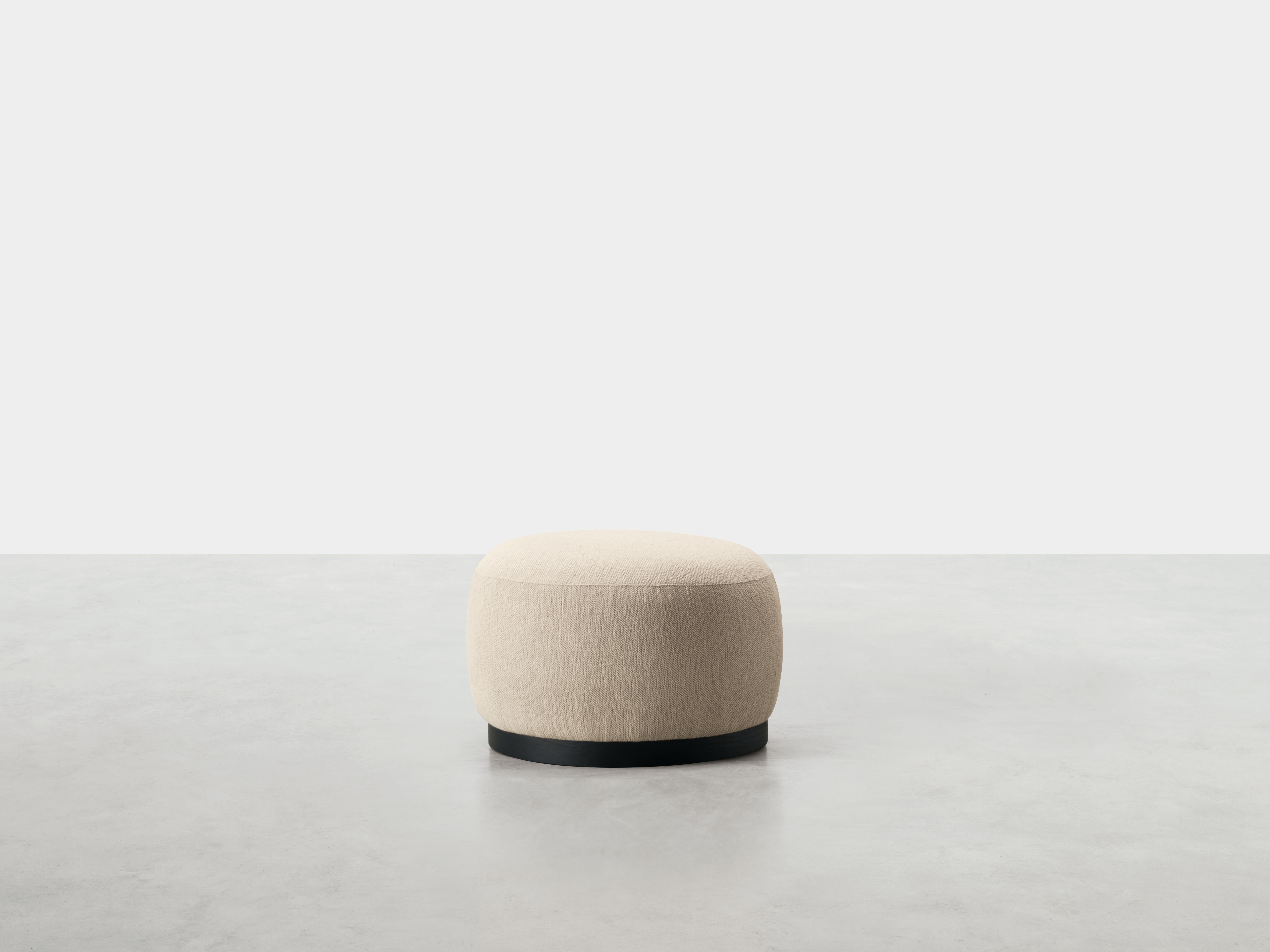 Boris Pouf by Somaschini
Dimensions: D 64 x H 40 cm
Materials: Solid wood structure padded with polyurethane foam in different densities. Pre-upholstery in polyester wadding, upholstery in fabric or leather covering. Base with Black Ash veneer in