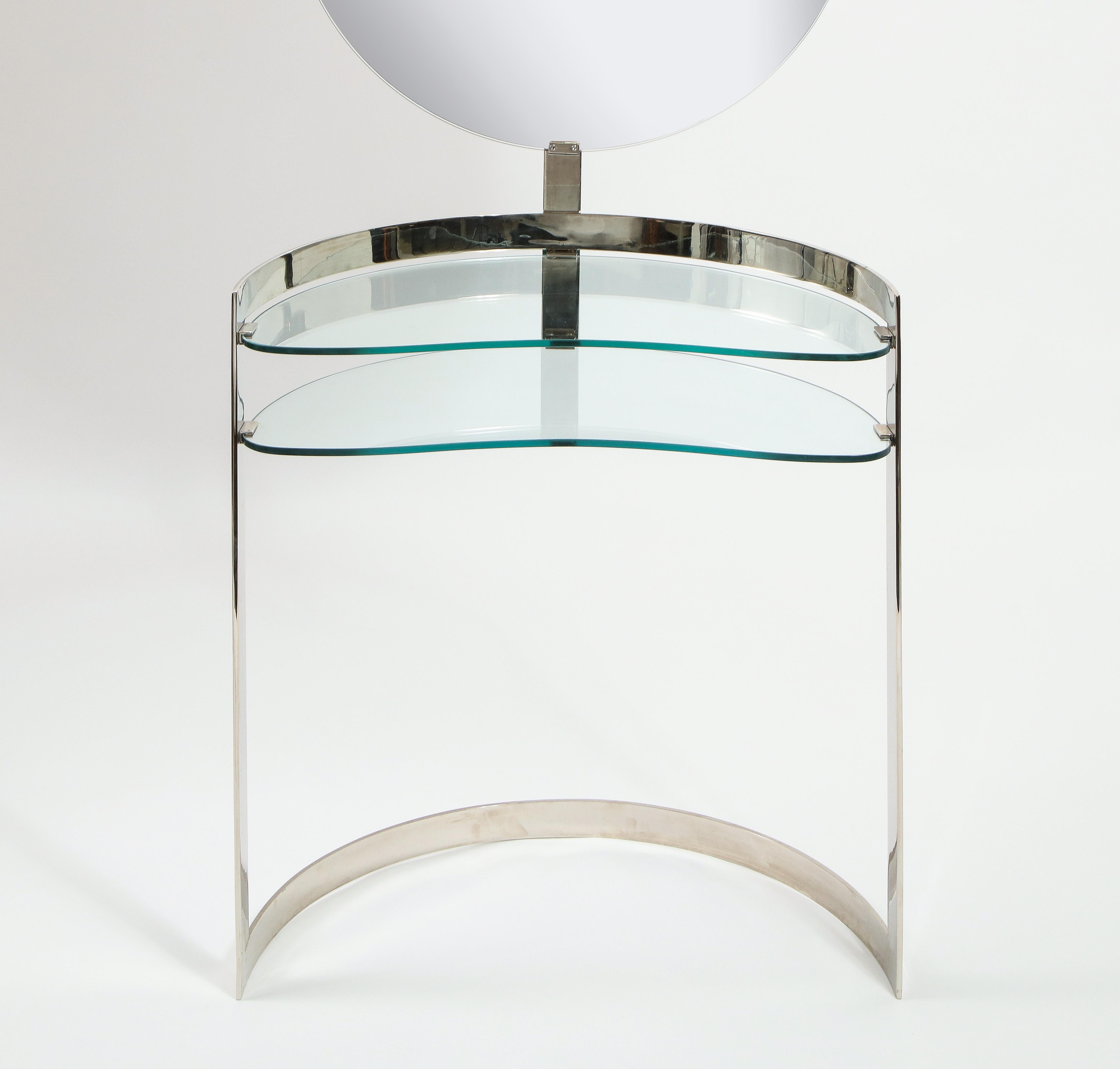 Nickel and glass vanity in the style of Boris Tabacoff with adjustable light, the two-tiered bean-shaped glass levels complement the curved shape of the frame, the mirror is backed in polished stainless so the vanity can be floated.