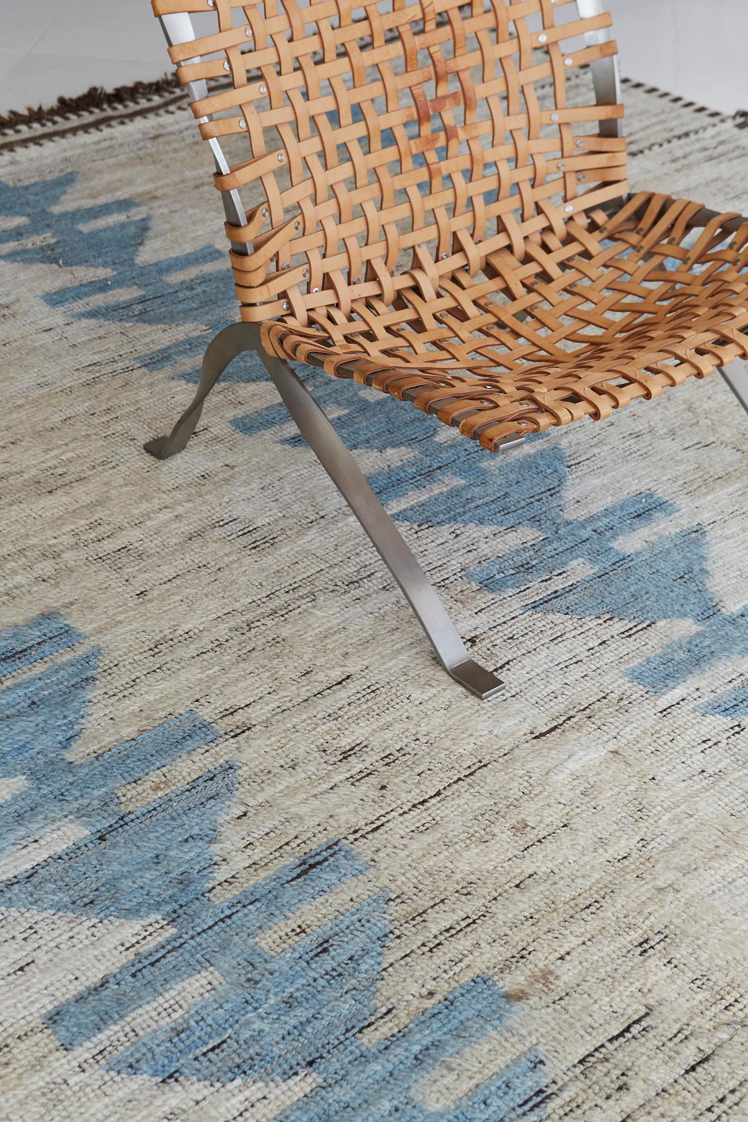 The 'Borlange' rug is a handwoven wool piece inspired by vintage Scandinavian design elements and recreated for the modern design world. The rug's shag balance and harmony, handwoven with an ivory flat weave and unique piles of tortoise blue,