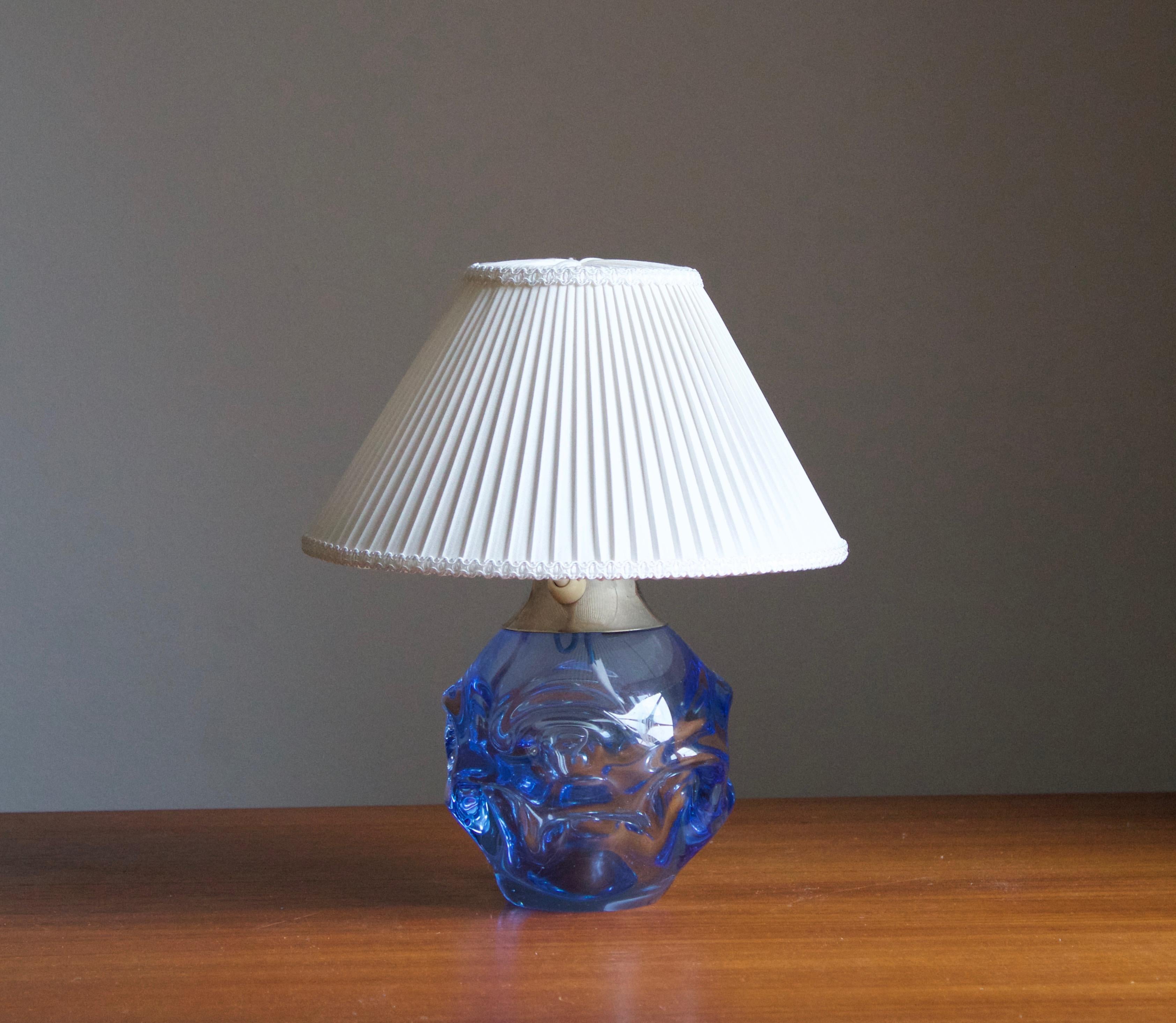 A small organic table lamp in highly artistic form. Design attributed to Börne Augustsson, Åseda Sweden, 1950s. Production by Kosta, labeled.

Stated dimensions exclude lampshade, height includes socket. Upon request illustrated lampshade can be