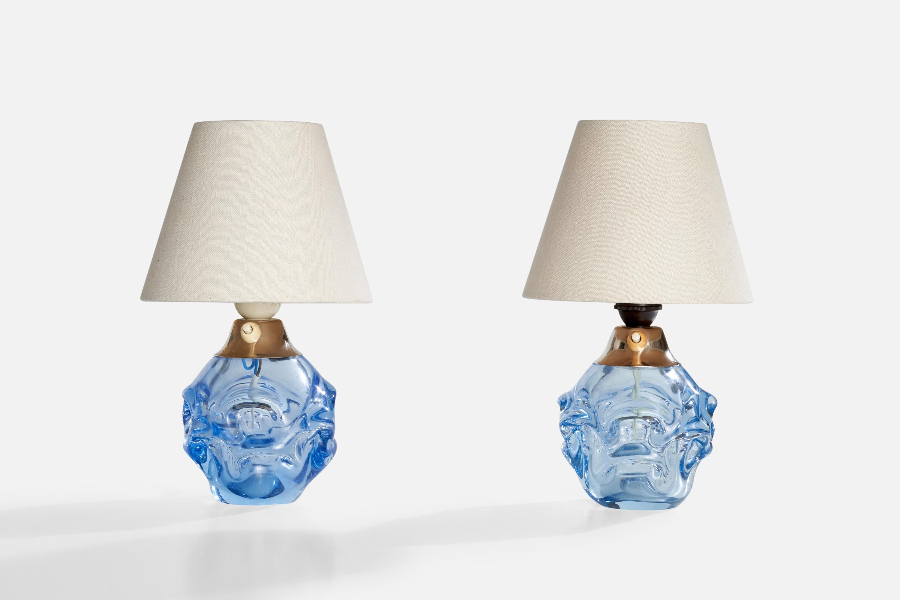 A pair of blue-colored glass table lamps designed by Börne Augustsson and produced by Åseda Glasbruk, Sweden, c. 1940s.

Dimensions of Lamp (inches):  7.5” H x 5” diameter 

dimensions of shade: 4” top diameter x 7.125” bottom diameter x 5.75”