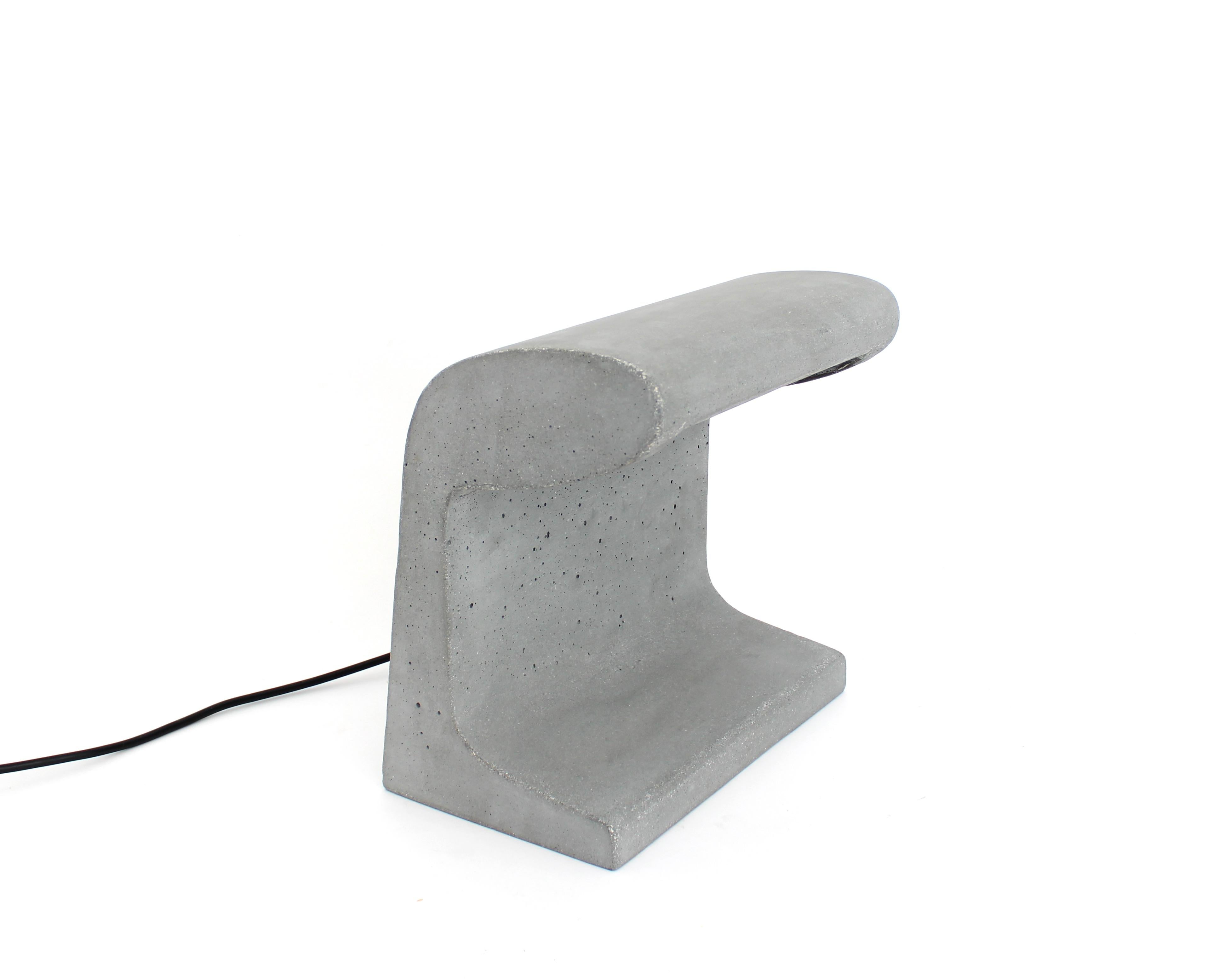 Borne Bétone Petite table lamp by Le Corbusier. 
Current production manufactured in France by Nemo Lighting. Concrete outdoor and indoor floor and table lamp, conceived for the Unité d’habitation de Marseille and for Bhakra Dam, Sukhna Dam in India