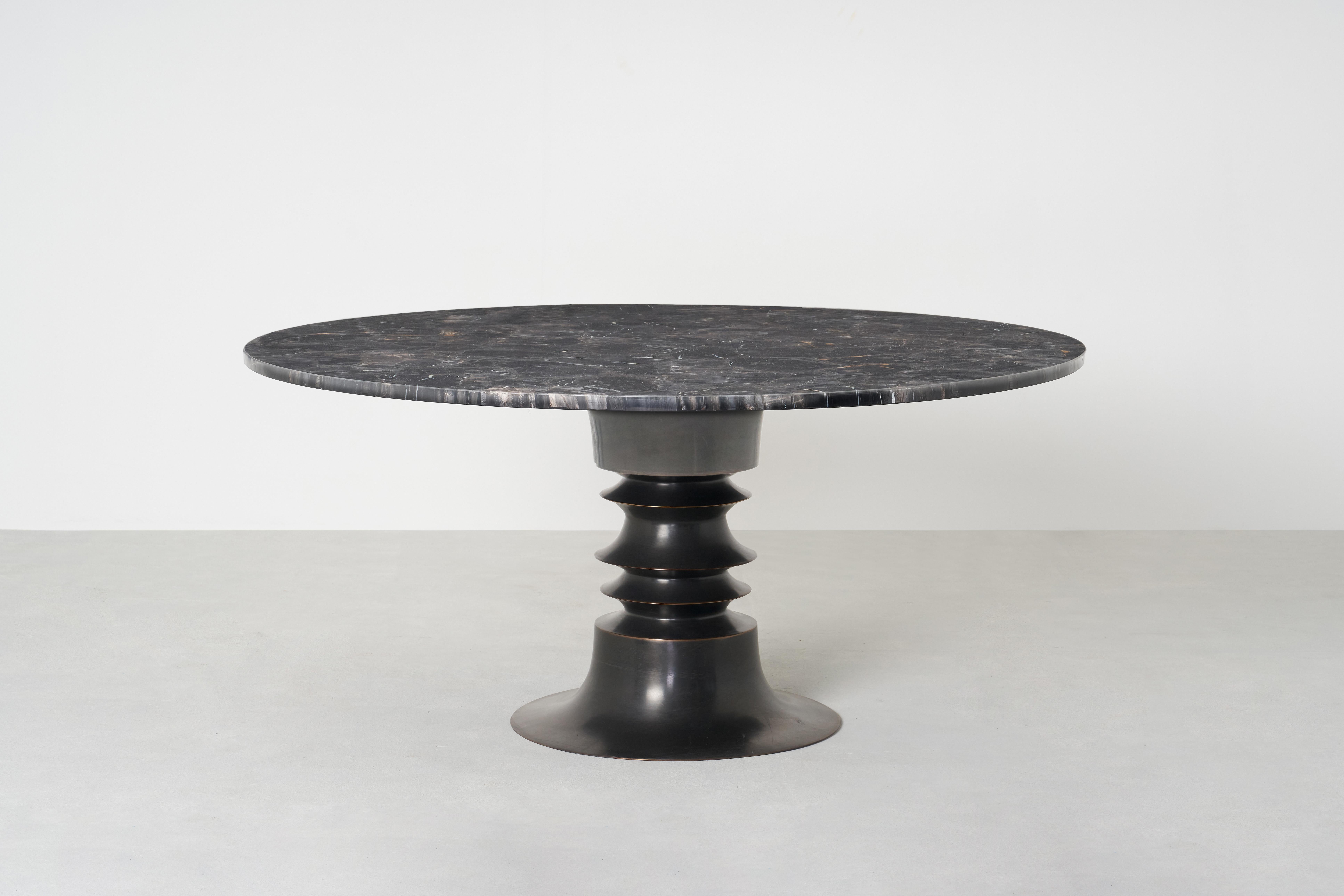 The ancient Indonesian temple of Borobudur lends the gentle curves of its famous stupas to this architectural table. Visual nuance is created through hammered sheets of tempered metal and tiers made from metal spinning.