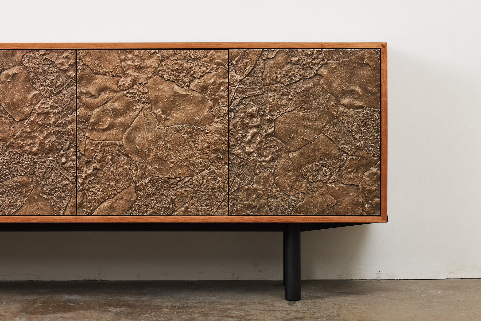 Crafted from cast bronze, steel, and cherry wood, the Borrowed Forms Credenza is the result of dozens of trips to forage for suitable stone formations in the Pacific Northwest. Hot jeweler’s wax is poured in place overtop of the found stones, and
