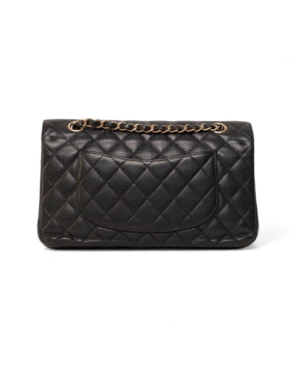 Borsa firmata Chanel, modello Timeless Double Flap, realizzata in pelle caviar nera con hardware oro. Doté d'une double patte, une esterna avec chiusura a girello logo CC, et une interna avec chiusura a bottone. Internamente rivestita in pelle