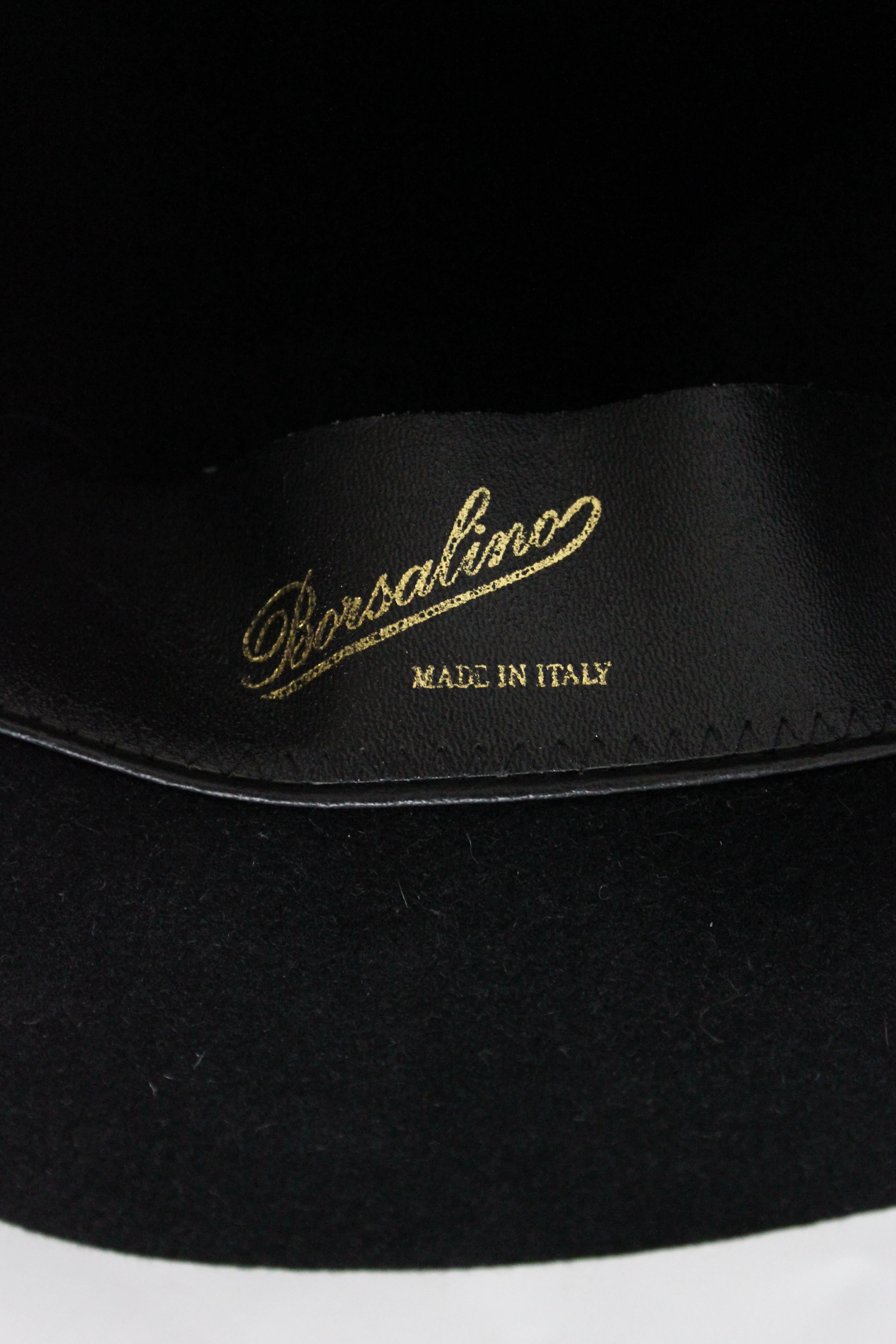 Borsalino vintage 90s hat. Fedora hat, black color. Felt fabric with ribbon along the circumference, closed by the typical bow. Made in Italy.

Condition: Excellent

Item used few times, it remains in its excellent condition. There are no visible