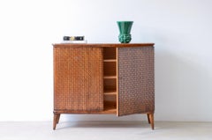 Borsani's elegant two-door cabinet with carved motifs.