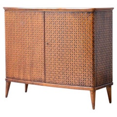 Borsani's elegant two-door cabinet with carved motifs.