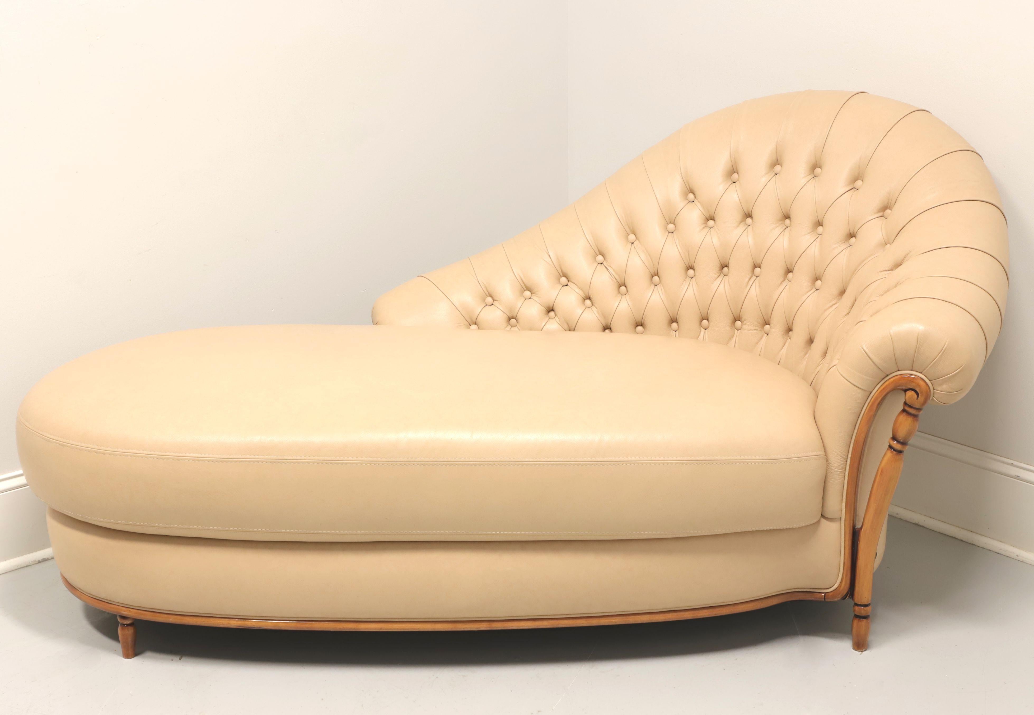 A Regency Style tufted chaise lounge by Borzalino. Genuine leather in a light tan color with maple frame. Features a button tufted high corner back, rolled arm, rounded long lounge cushion, decorative maple trim to apron & arm and toupie feet.