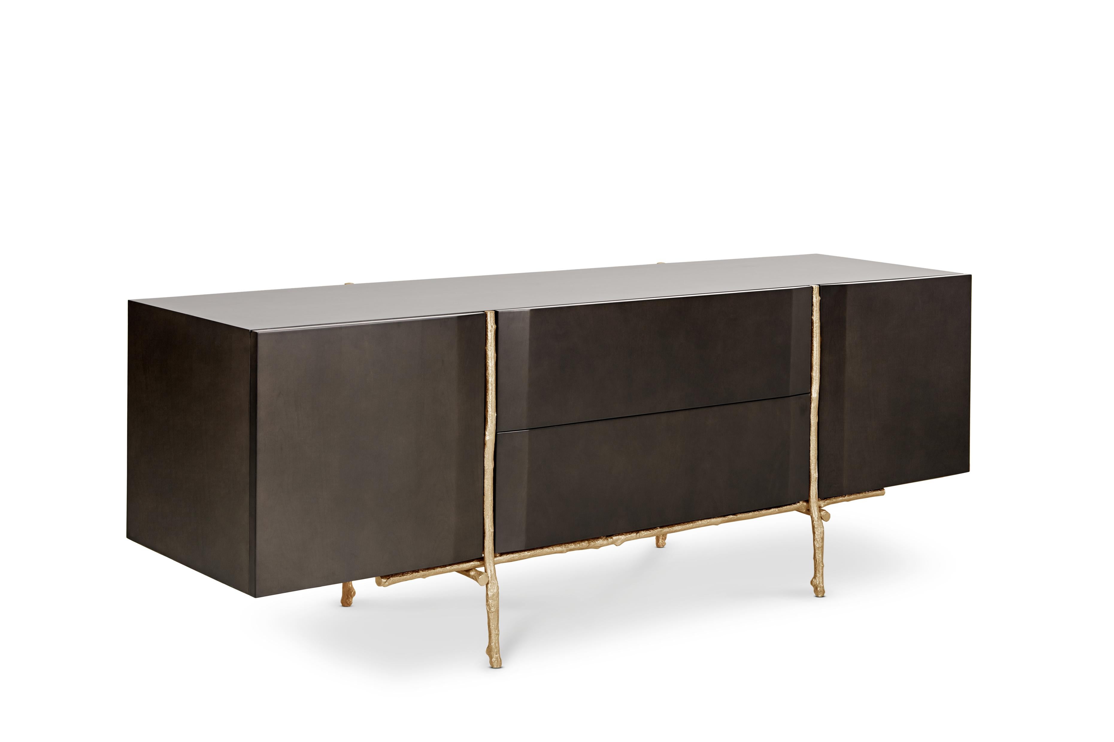 Bosque Sideboard by Ginger & Jagger
Dimensions: D 62 x W 220 x H 80 cm.
Materials: Wood and brass.
Finish: Body, Interior & Exterior: Night Jungle wood veneer with gloss finishing. Structure: Cast brass with Brass finishing.

This product is
