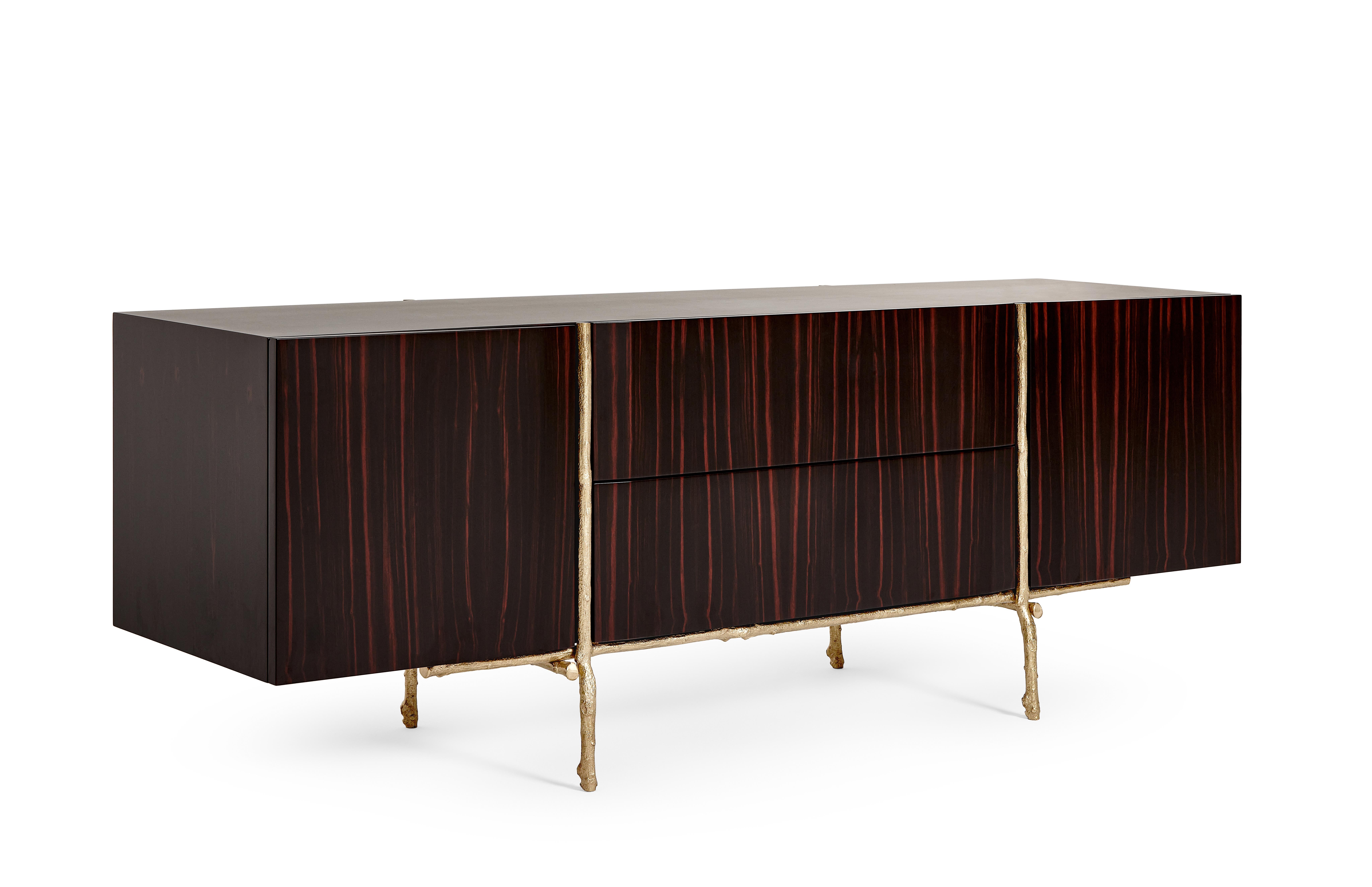 Bosque Sideboard by Ginger & Jagger
Dimensions: D 62 x W 220 x H 80 cm.
Materials: Wood and brass.
Finish: Body, interior, and exterior in Amara Ebony wood veneer in gloss finishing; structure in cast Brass in Brass finishing.

This product is