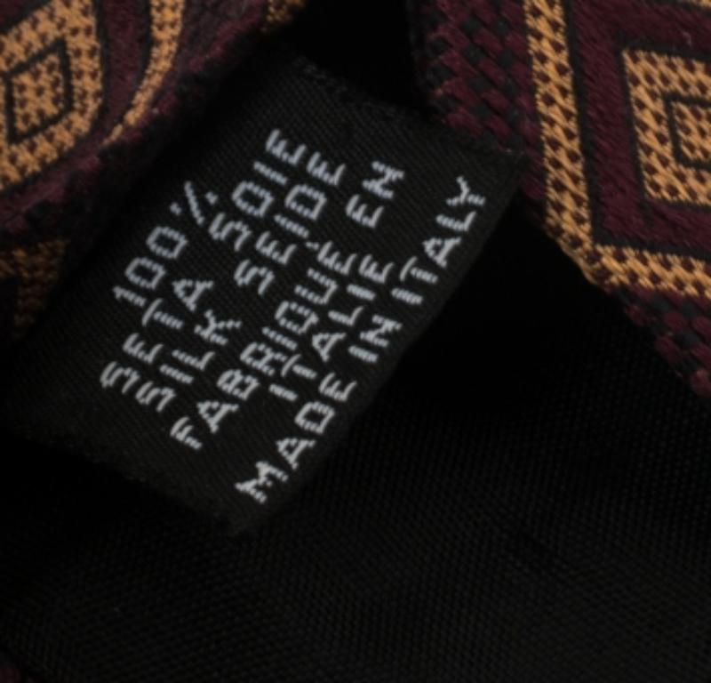 This Boss By Hugo Boss tie is a perfect formal accessory that has a sharp and modern appeal. Made from silk, it features a burgundy shade, square patterns all over, and the brand label neatly stitched at the back. It is sure to add oodles of style