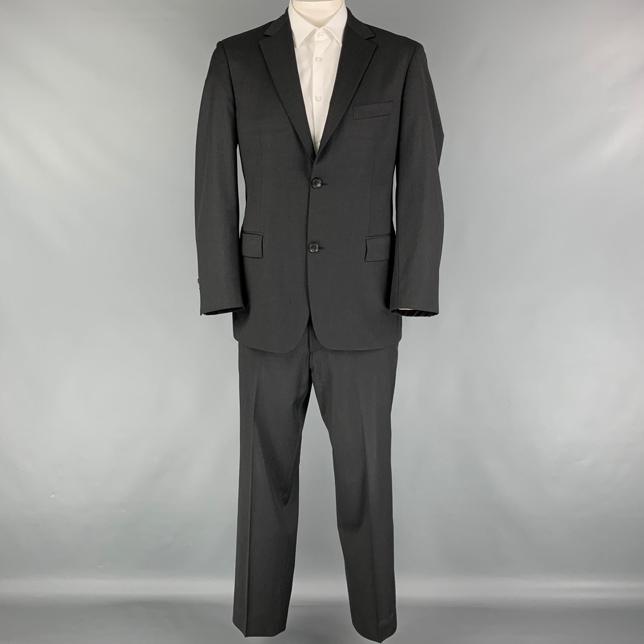 BOSS by HUGO BOSS suit comes in a charcoal virgin wool with a full liner and includes a single breasted, double button sport coat with a notch lapel and matching flat front trousers.

Very Good Pre-Owned Condition.
Marked: