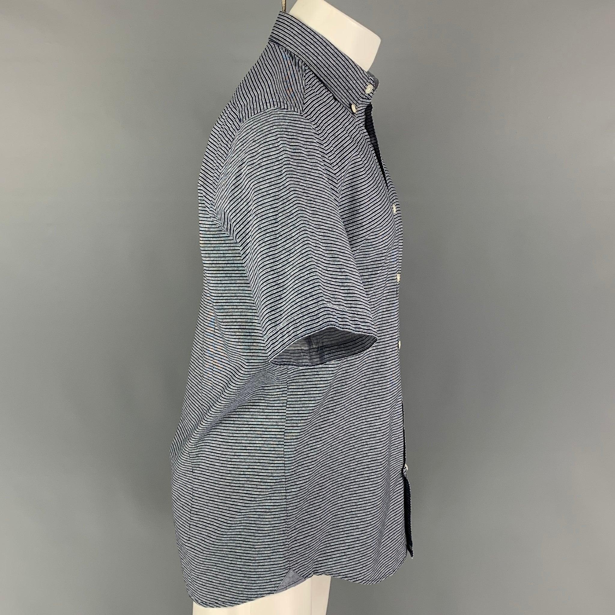 BOSS by HUGO BOSS short sleeve shirt comes in a navy & white stripe cotton featuring a regular fit, button down collar, and a button up closure.
Very Good
Pre-Owned Condition. 

Marked:   M  

Measurements: 
 
Shoulder: 17.5 inches  Chest: 40 inches