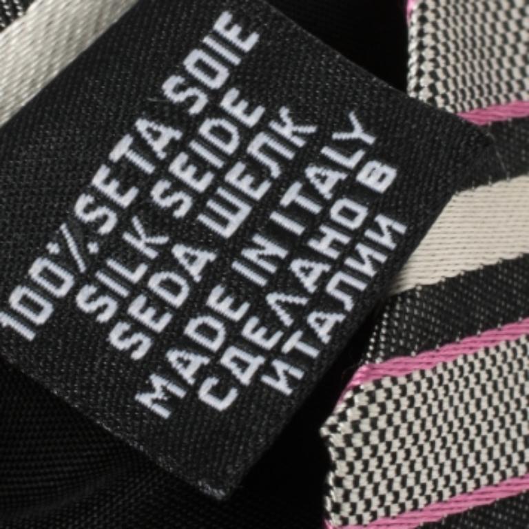 This Boss By Hugo Boss tie is a perfect formal accessory that has a sharp and modern appeal. This 100% silk tie features a diagonal striped pattern and is tailor-made for the modern man like you. It is finished with a Penny keeper strap and the