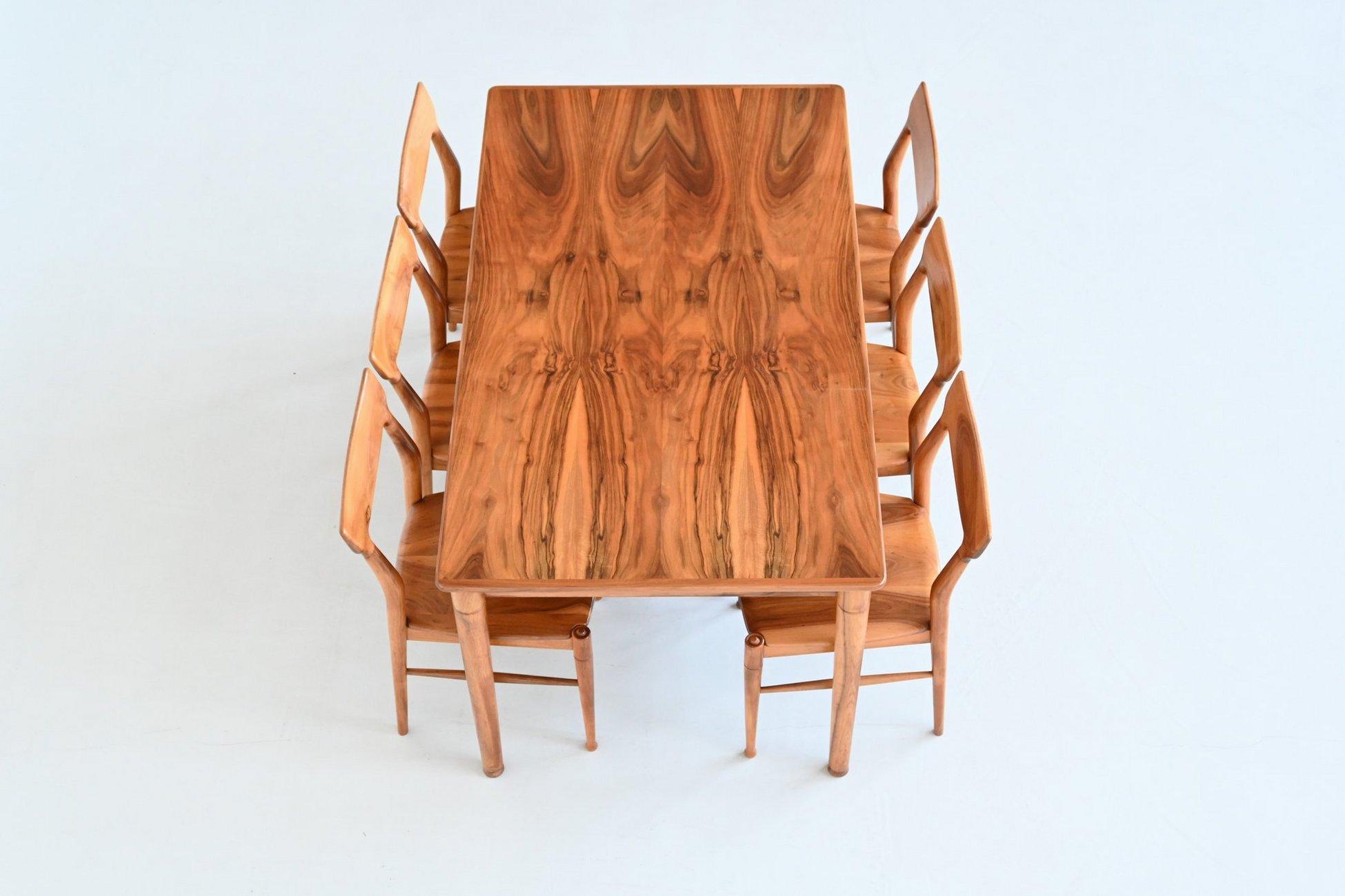 Fantastic and unique dining table designed and manufactured by Bosteels Meubelen in Sint-Niklaas, Belgium 1960. This very nicely shaped table is made of beautifully grained walnut supported by six sculpted solid walnut legs. This remarkable table
