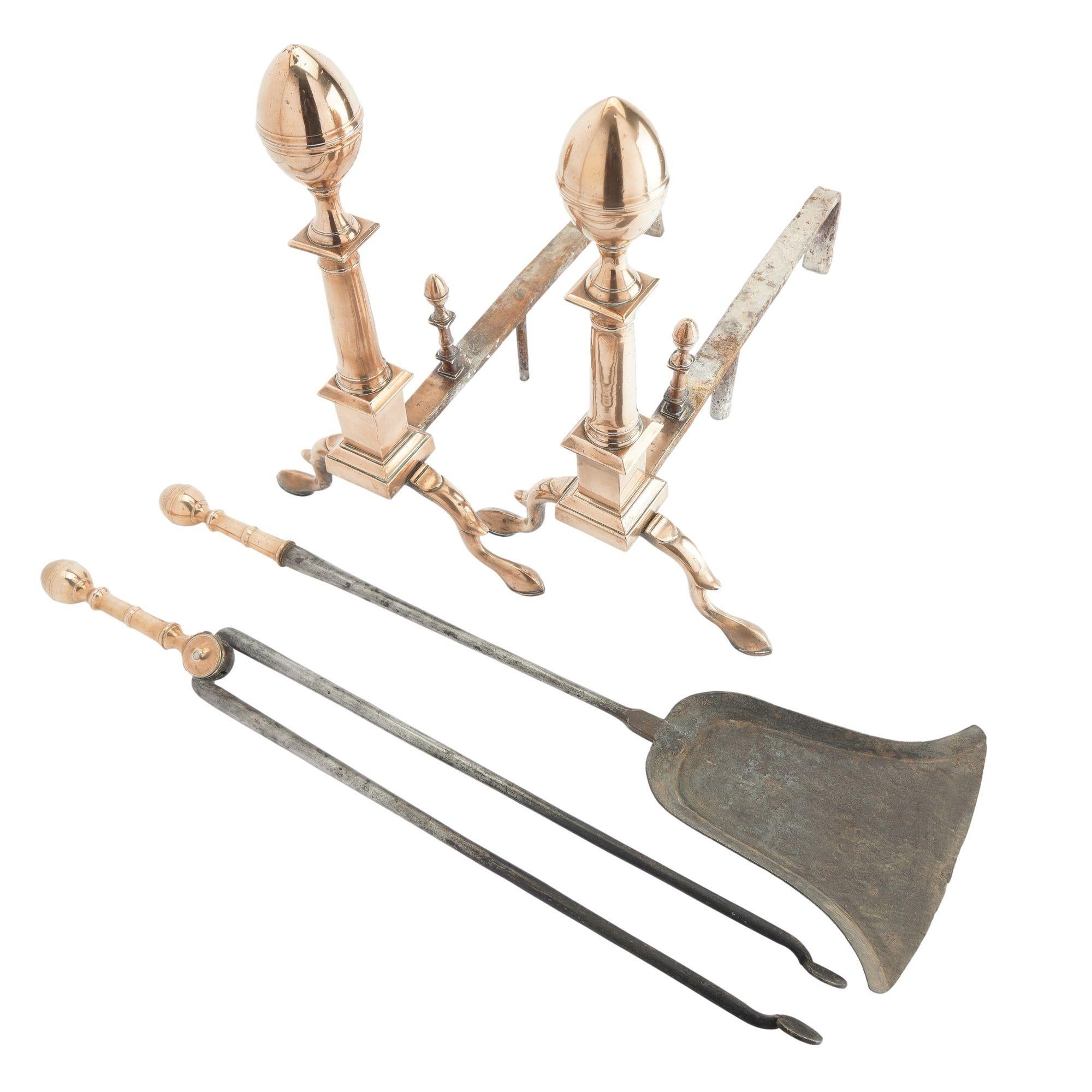 Pair of cast bell metal brass lemon top andirons with matching fire tools.

The andirons feature oval lemon finials which sit on a Doric column with plinth, and the cast arched legs with spurs rest on finely formed slipper pad feet. The crossing