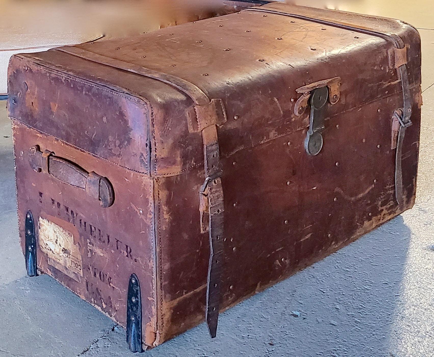Please message us for a cost effective shipping quote to your location.

Leather Travel Trunk. Brass Lock marked 1864. Brass Rivets on top. Iron wheels at
corner. Wood Slats at bottom. Linen Lined. Says: L. H. Wheeler Boston USA on side.
  
From