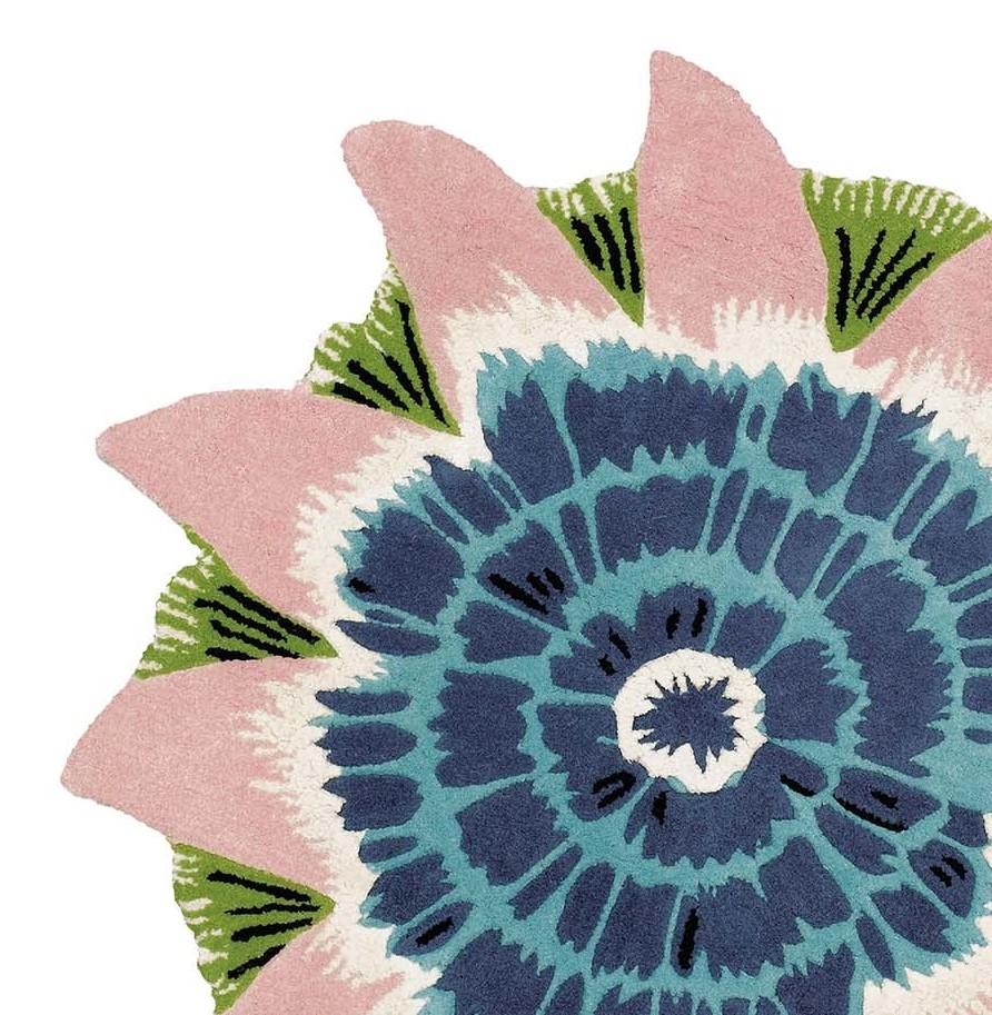 Reminiscent of the sophisticated shades of kaleidoscopes, this exceptional rug will make a bold statement in any modern or Minimalist interior. Artfully fashioned of wool and viscose, this rug boasts a delicately unfolding flower with a