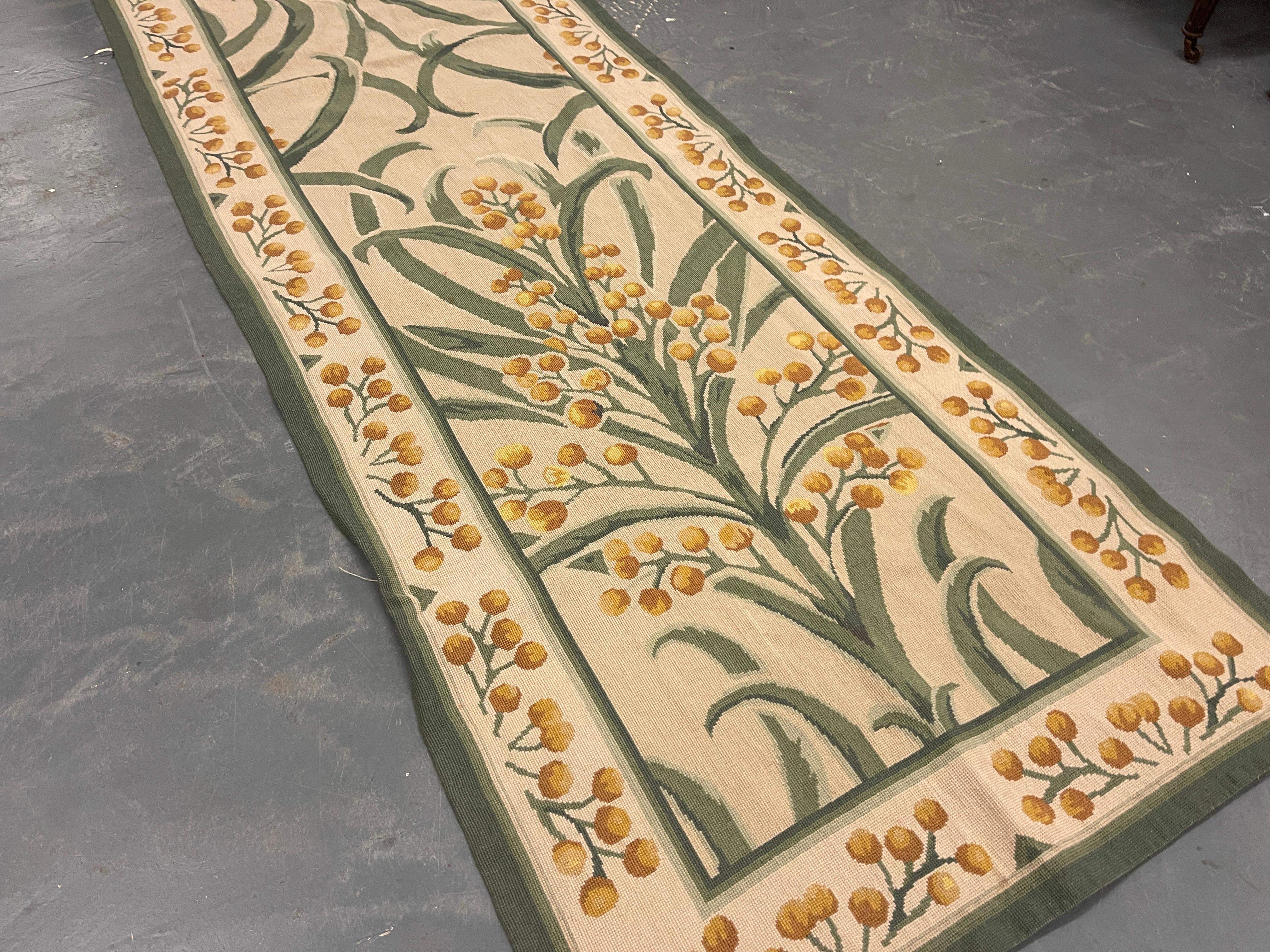This fantastic area runner rug has been handwoven with a beautiful symmetrical floral design woven on an ivory beige green background with cream green and ivory accents. This elegant piece's colour and design make it the perfect stair runner