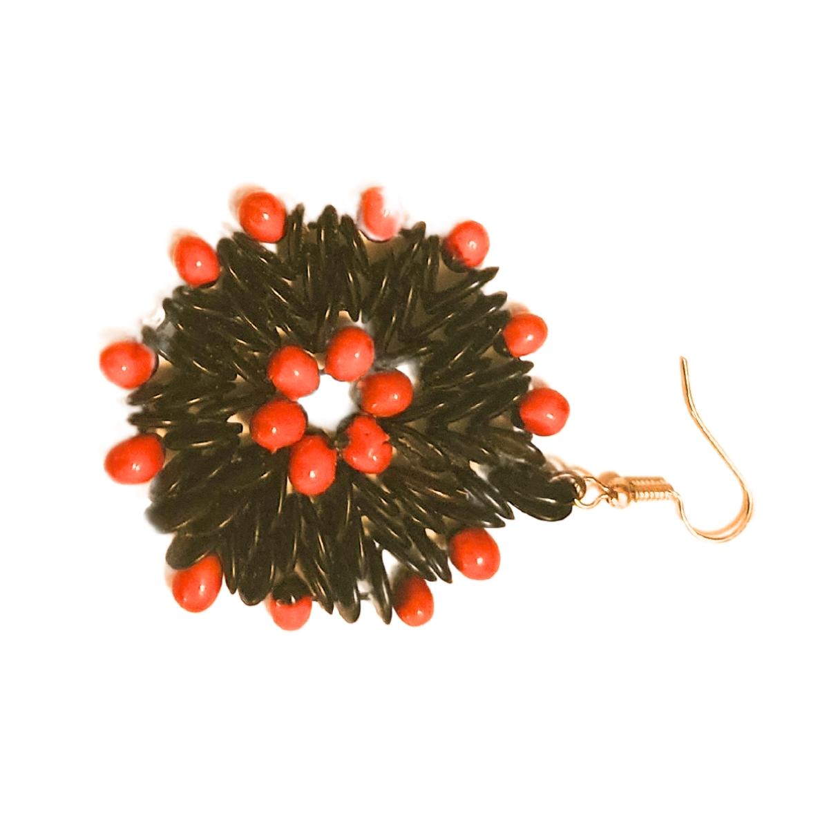 The Crimson Halo Earrings present a striking combination of nature's finest materials, featuring a circle of vibrant red jumbie beads at the center, surrounded by sleek black tamarind seeds. The circular formation creates a beautiful 