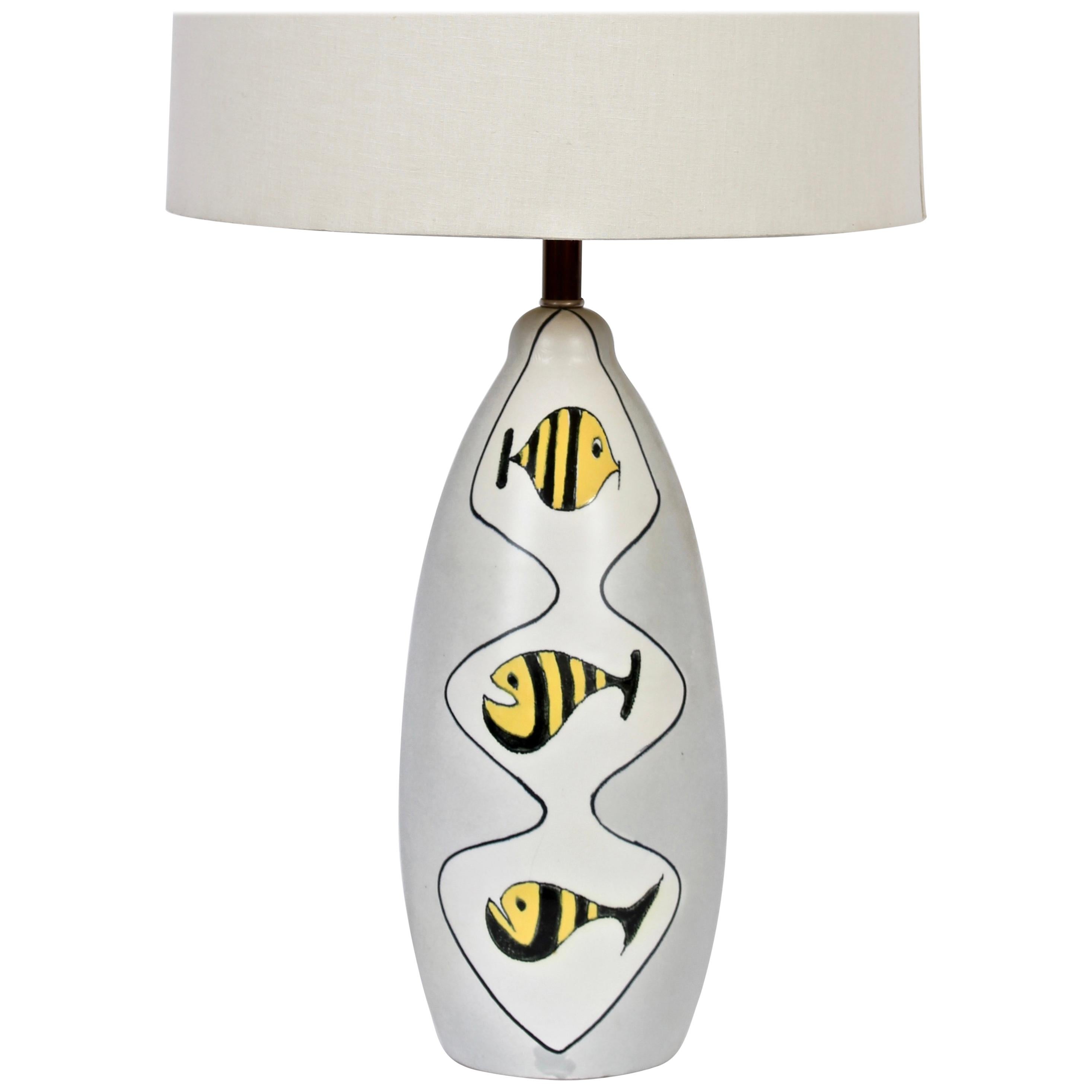 Italian Modern Bitossi attributed bumblebee fish matte gray glazed pottery table lamp. Featuring hand painted black lined white encased background with a stacked trio of yellow and black striped fish. Shade shown for display only and not for sale