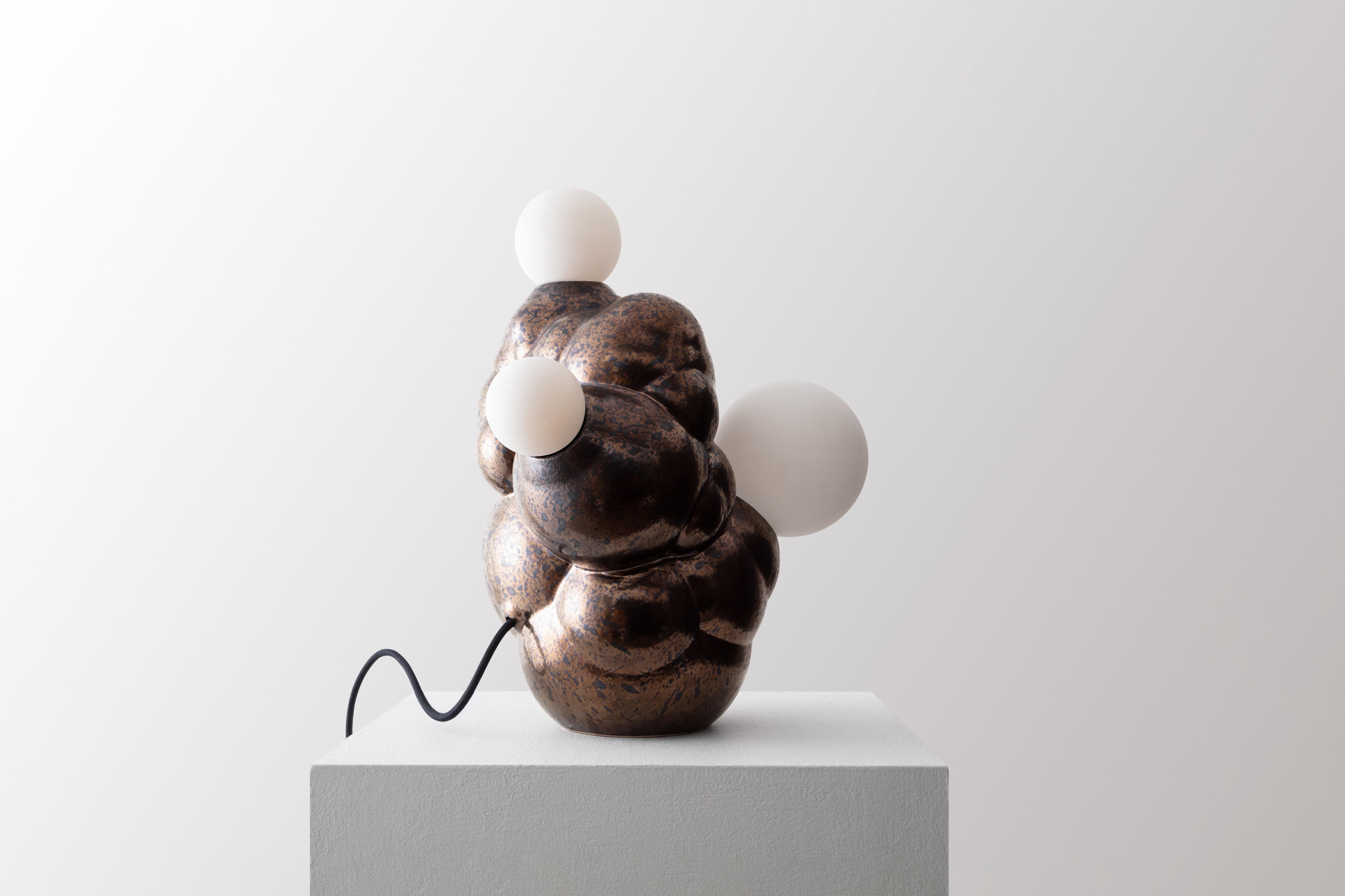Botryoidal Table Lamp by Forma Rosa Studio
Dimensions: D 35.5 x W 30.5 x H 50.8 cm.
Materials: Ceramic, brass.

Available in Charcoal and Bronze colors.

Our Bubbly Lamp is digitally grown to imitate the fractal growth of botryoidal crystals in