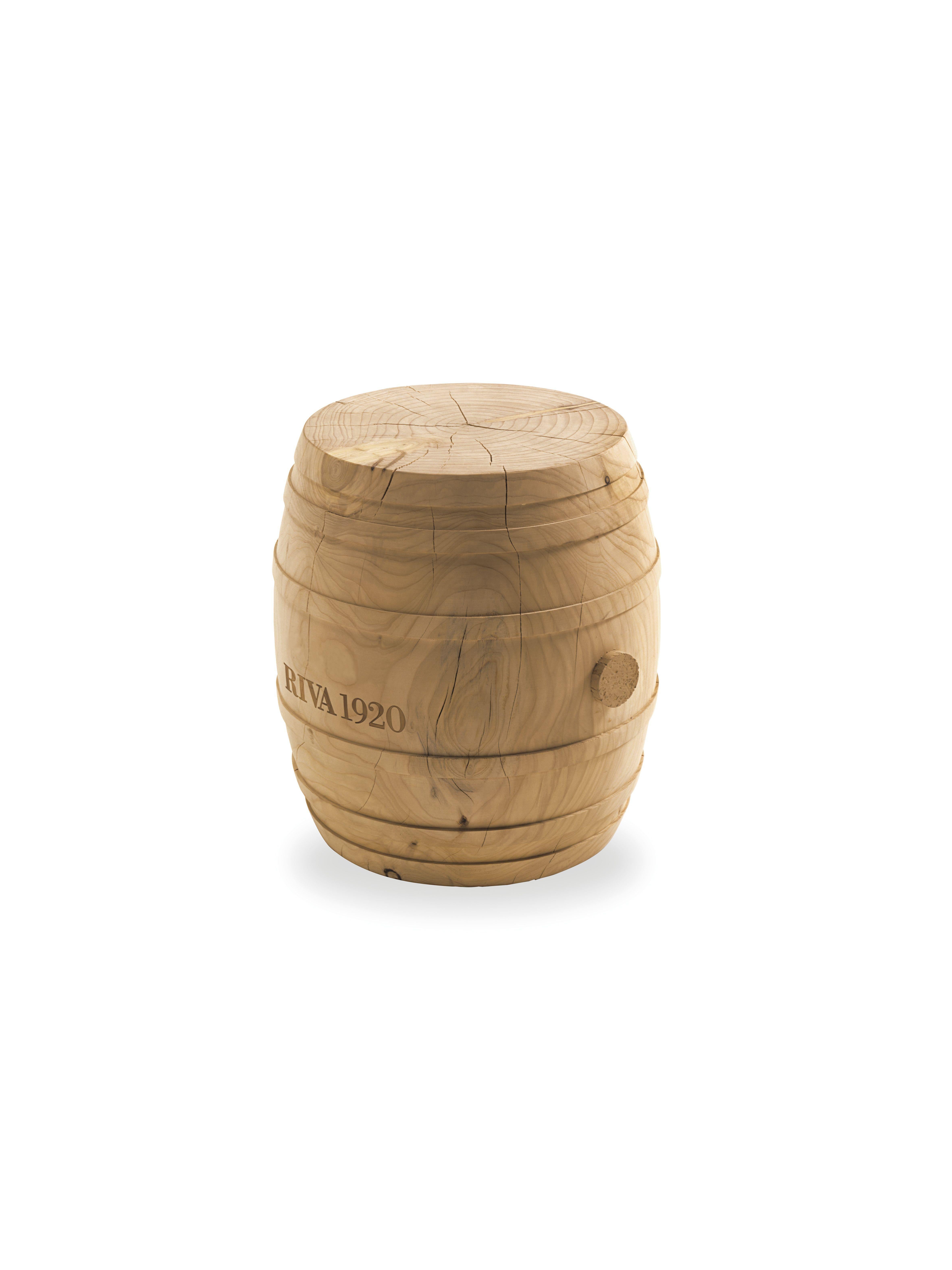 Stool made from a single block of scented cedar that is inspired by the shape of a circular barrel.