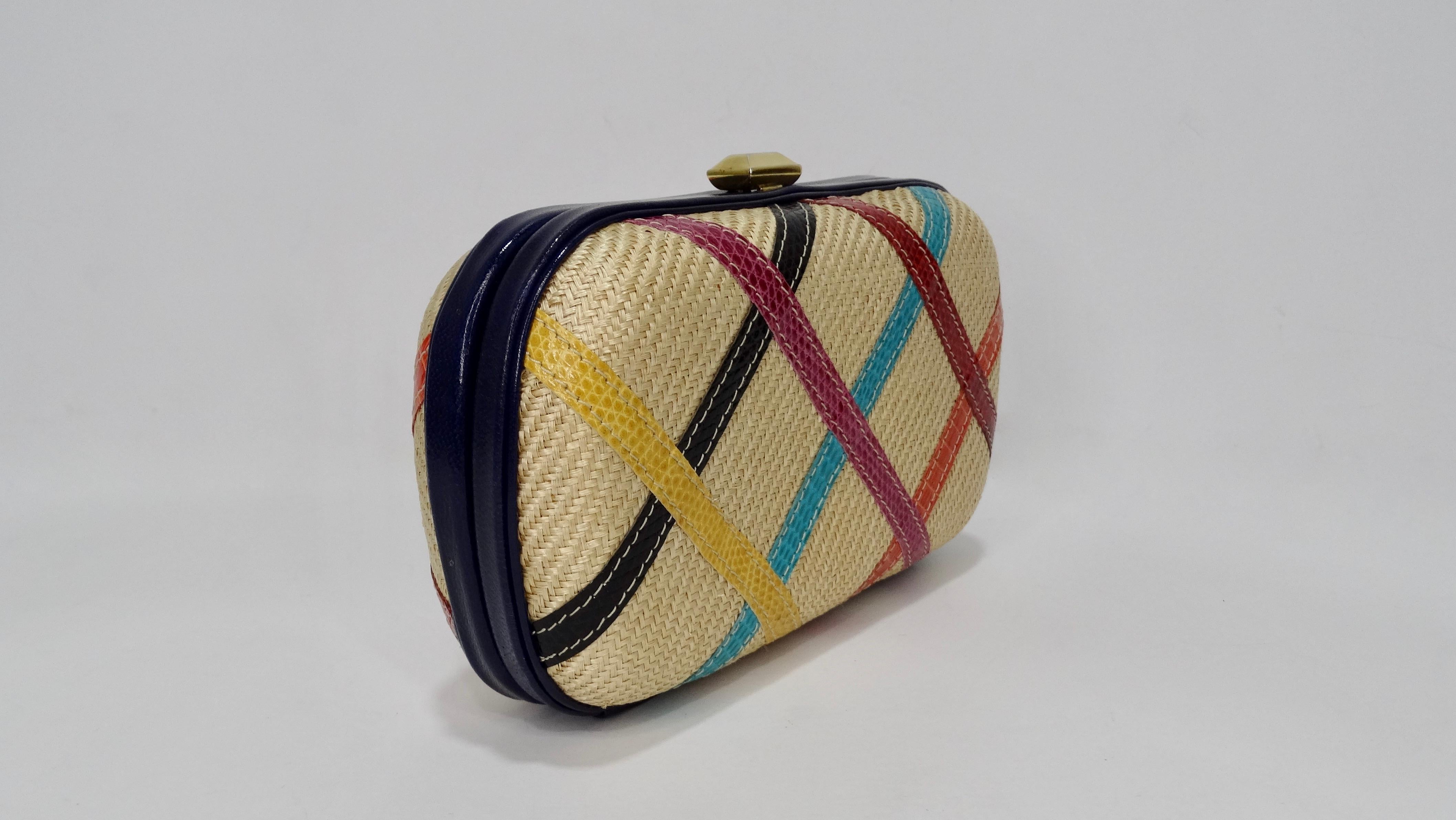 Add some vintage to your Summer/Spring looks! Circa 1970s, this Bottega clutch is crafted from woven raffia with a quilted pattern made from multi-colored leather. Navy blue leather trims the bag with a top clasp closure that opens to a champagne