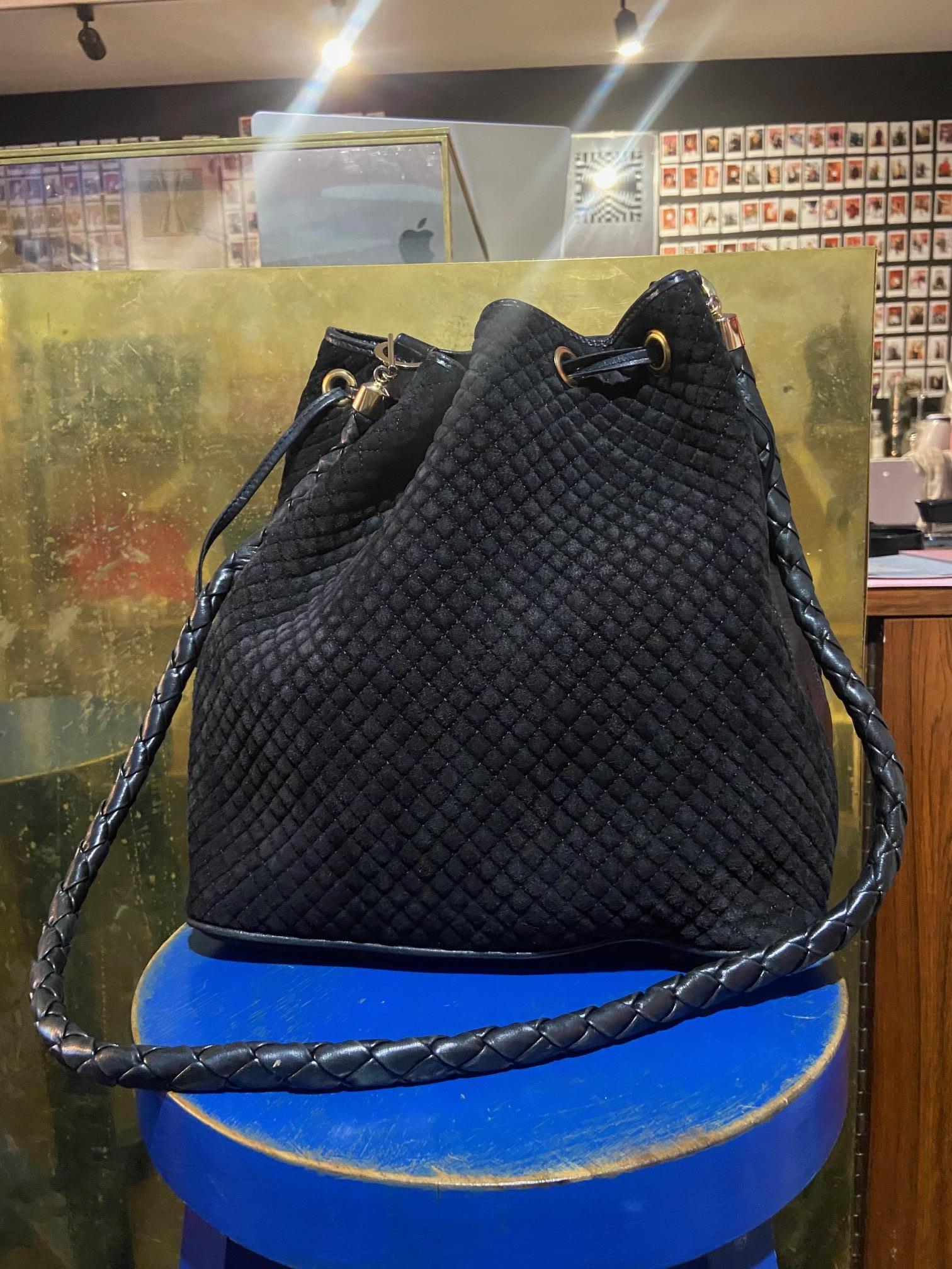 Vintage Bottega Black Suede Bucket Bag Features diamond effect throughout the suede of front and back of bag. Black leather adjustable handle, pull to tighten! Typical of Bucket bags. Red lining with inside pocket.  In excellent vintage condition.