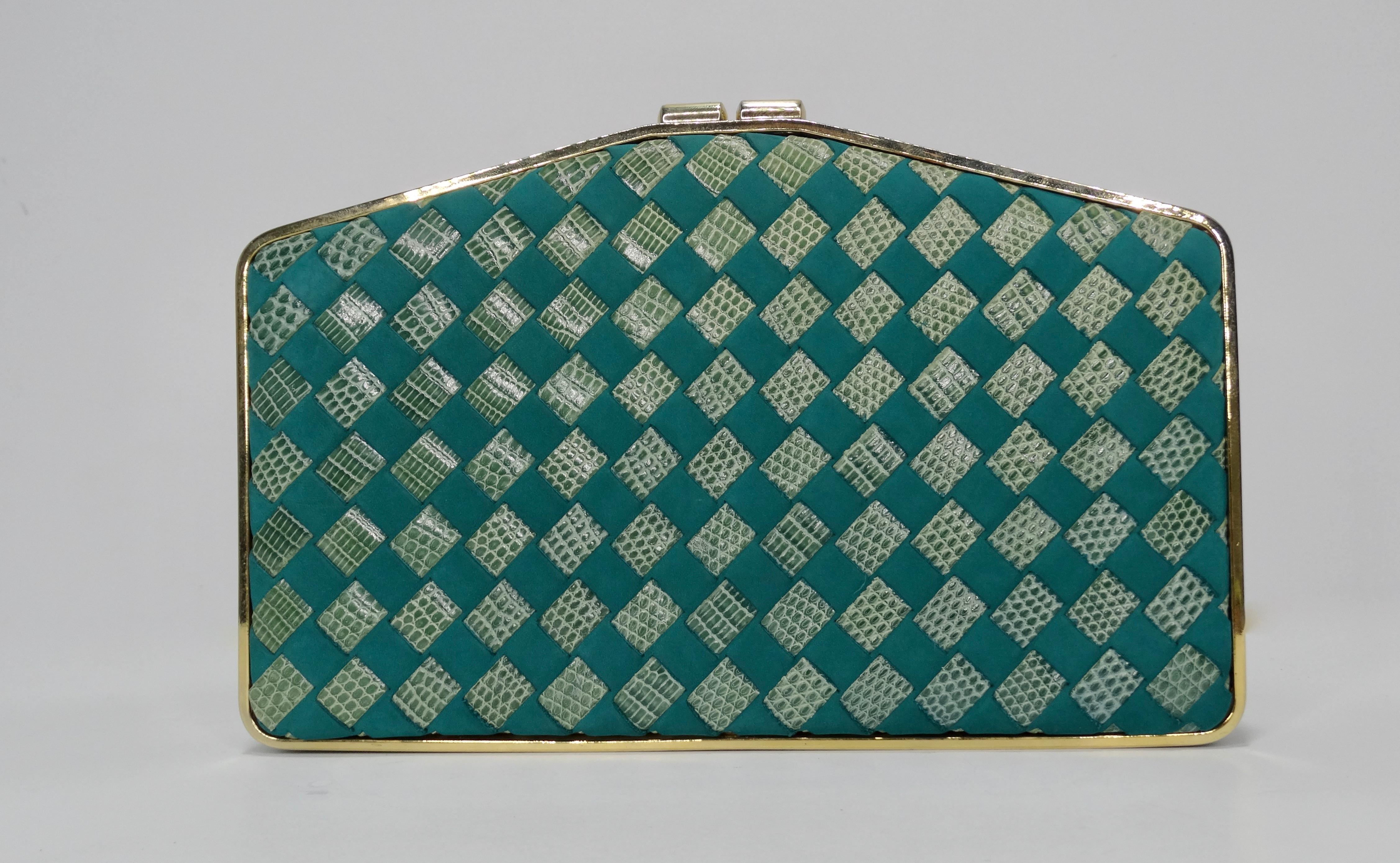 Let's talk vintage! This stunning Bottega Veneta clutch from 1988 features hues of blues and green woven lizard skin and leather. Gold hardware is featured throughout and satin emerald green is featured inside. This clutch also includes an