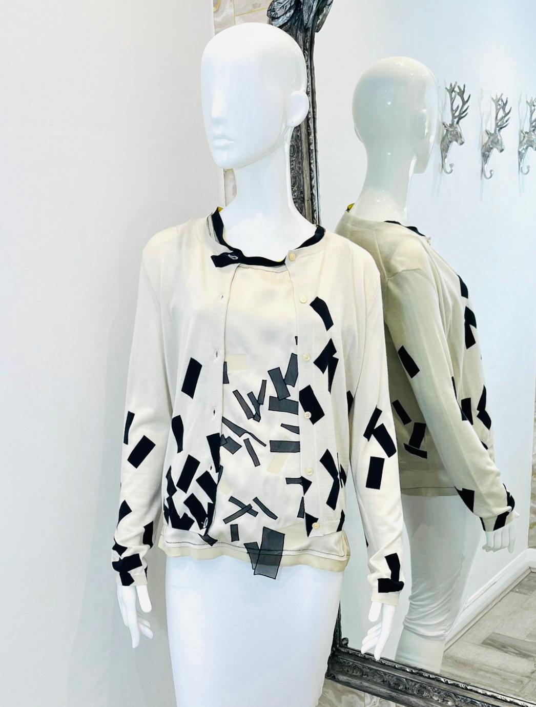 Bottega Veneta 3D Layered Silk & Cashmere Printed Top & Cardigan Set

Ivory set designed with black geometric prints to the front.

Sleeveless top styled with 3D layered effect detailed with black trimmings to the round neckline and shoulders with