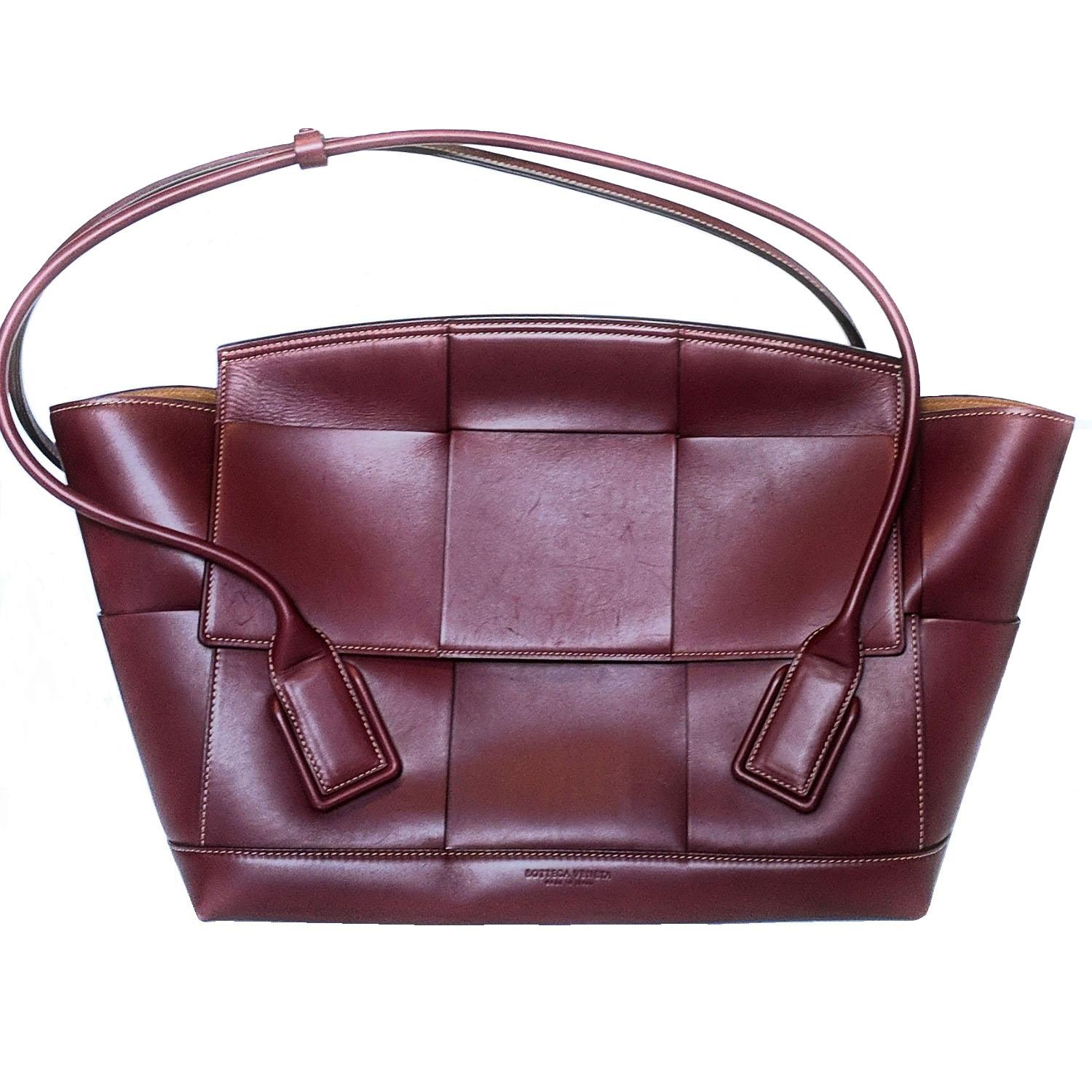 Bottega Veneta’s large burgundy leather The Arco bag is presented in various hues throughout the Pre-AW19 lookbook and woven with a scaled-up version of the label’s signature Intrecciato technique. Top rolled leather handle secured with a
