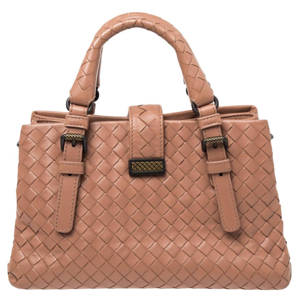 This Bottega Veneta tote is a creation that brings joy to one's sight! It has been beautifully crafted from leather and designed in their signature Intrecciato pattern while being held by two top handles. The bag is also equipped with a flap