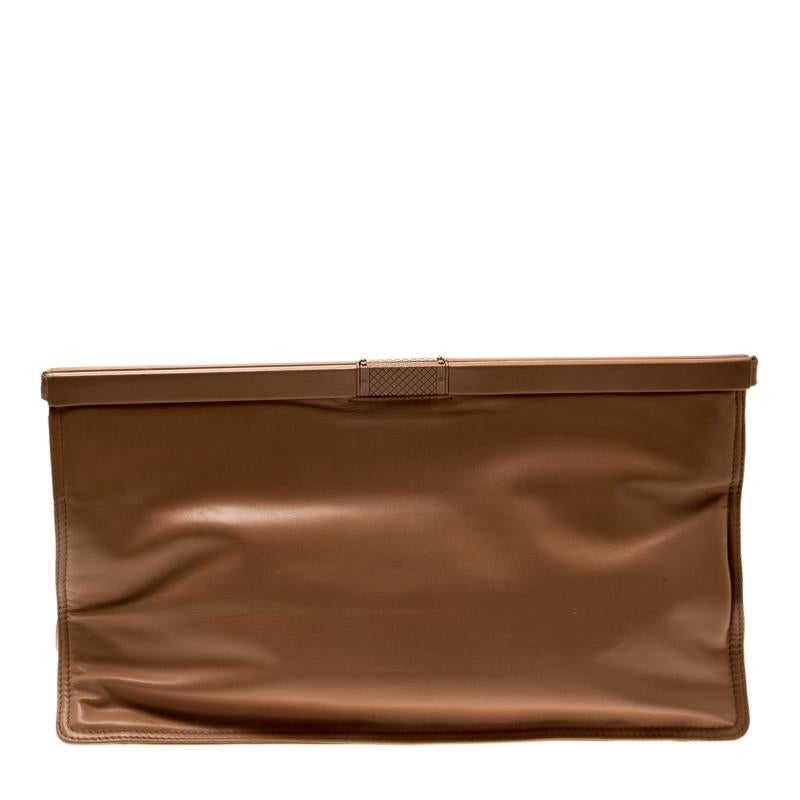 This clutch from Bottega Veneta will add instant charm to any of your outfits. The beige clutch is crafted from leather in a plain design but a grand size. It has one spacious satin-lined interior and one zip pocket at the front. A timeless piece,