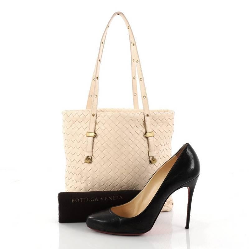 This authentic Bottega Veneta Belted Tote Intrecciato Nappa Medium is a statement piece you perfect for everyday use. Crafted in cream nappa leather woven in Bottega Veneta's signature intrecciato method, this oversized stylish tote features