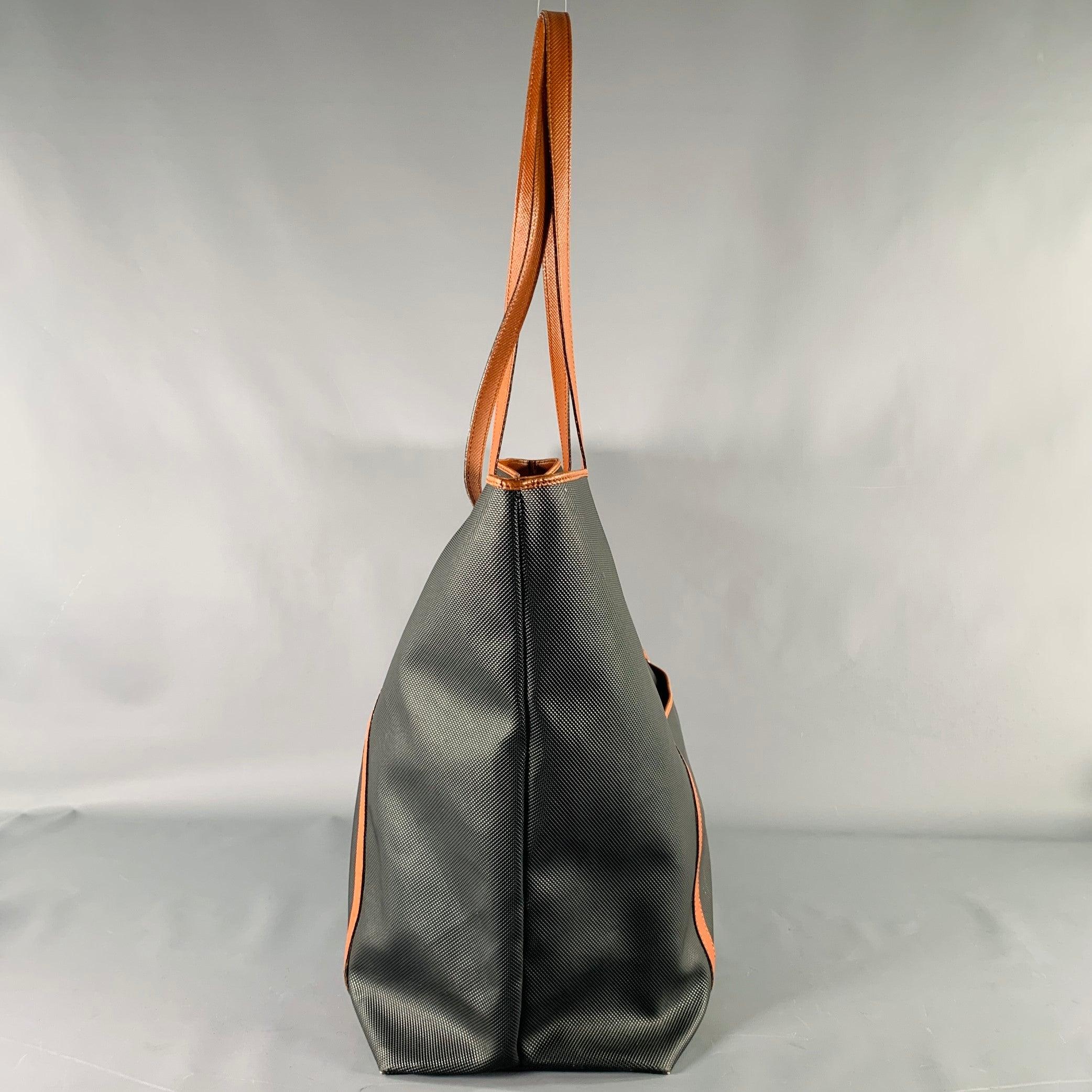 BOTTEGA VENETA handbag
in a brown and black
color block coated canvas fabric featuring a large tote style, top handles, and magnetic closure. Made in Italy.Very Good Pre-Owned Condition. Light wear. 

Marked:   6630086325255NCL 

Measurements: 
 