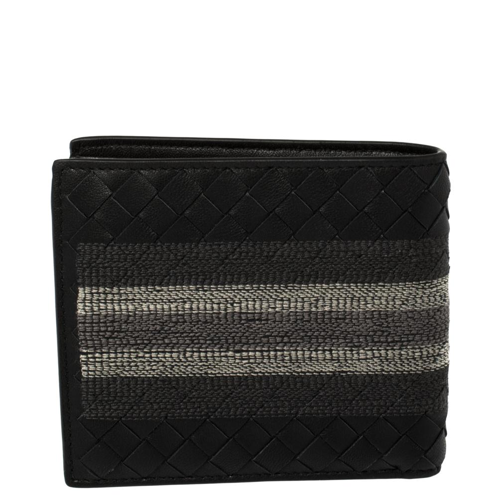 Bottega Veneta's signature Intrecciato pattern adorns the black leather body of this bifold wallet. It is highlighted by a stripe detail that runs through the center of the exterior. Functional and compact, it is equipped with multiple card slots