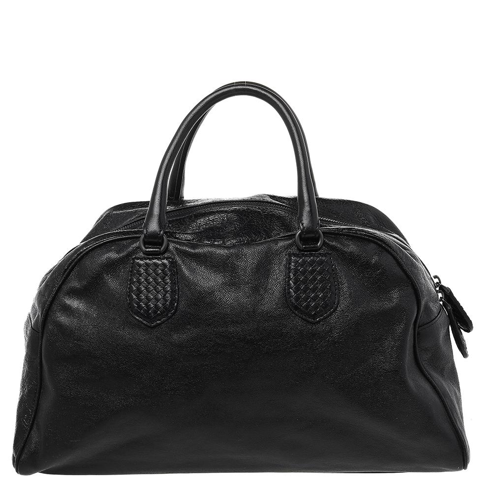 This finely crafted Bowling bag by Bottega Veneta has been designed to assist you with ease and style on all days. Fashioned using Intrecciato leather and karung leather, the black Bowling bag has two handles, black-tone hardware, and a spacious