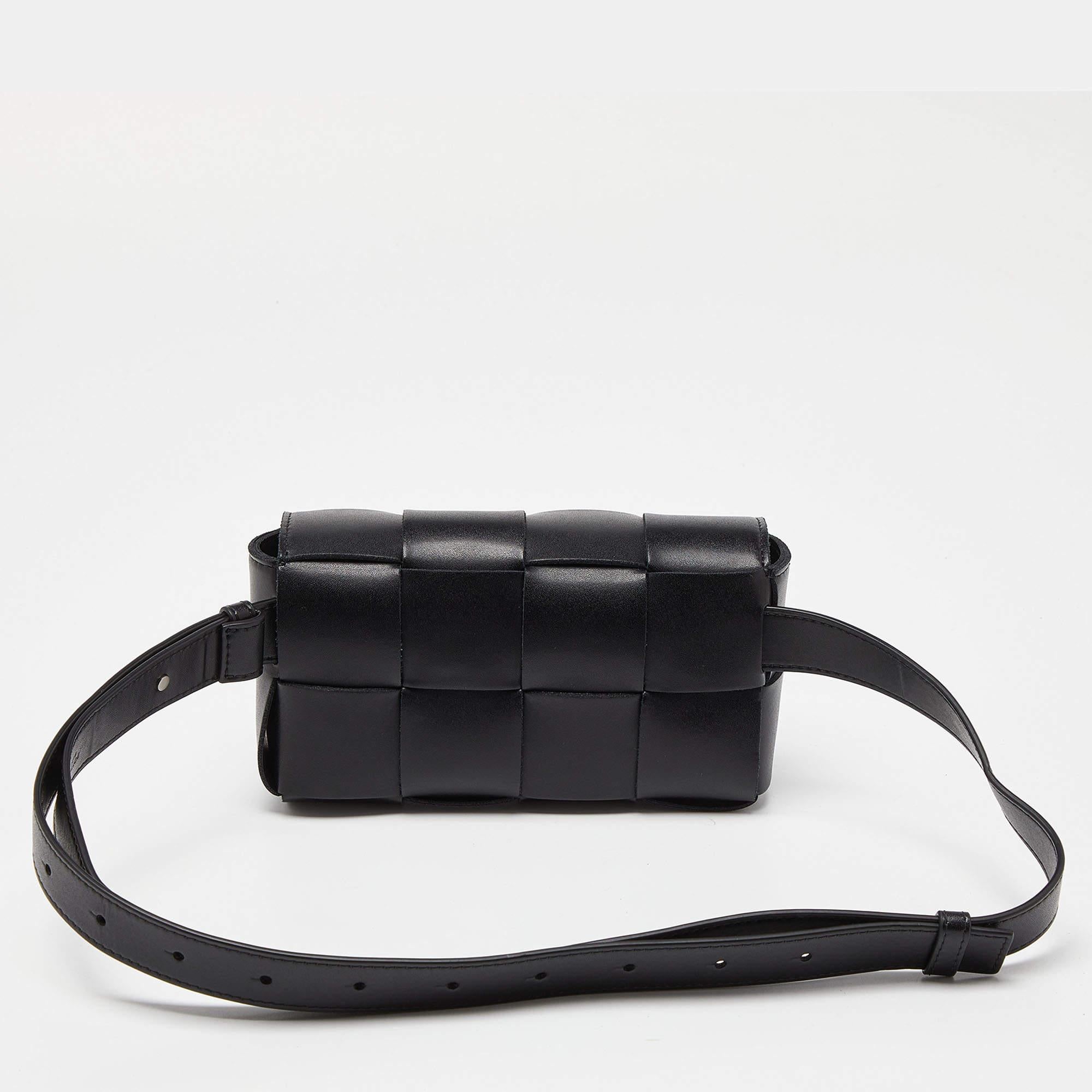Crafted from exquisite leather in the brand's signature intrecciato weave, this mini Cassette belt bag from Bottega Veneta features an adjustable belt strap for hands-free wear. It's the perfect blend of functionality and elegance, making it an