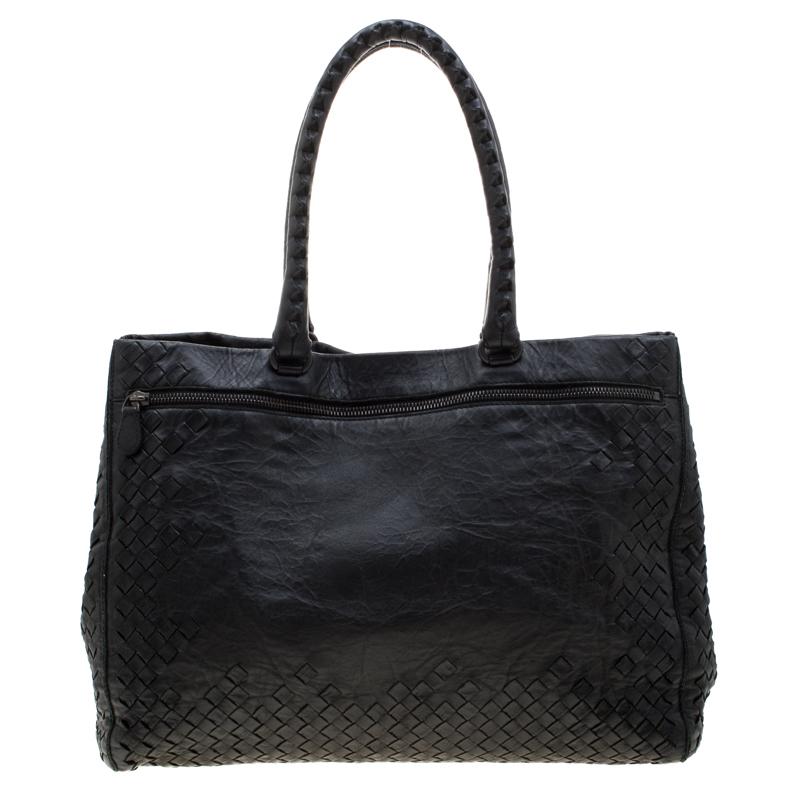 This classic black tote from Bottega Veneta is simple yet stylish. Crafted from leather, the bag is designed to complement the wants of women with an on-the-go lifestyle. It features double top handles and a capacious suede interior with ample space