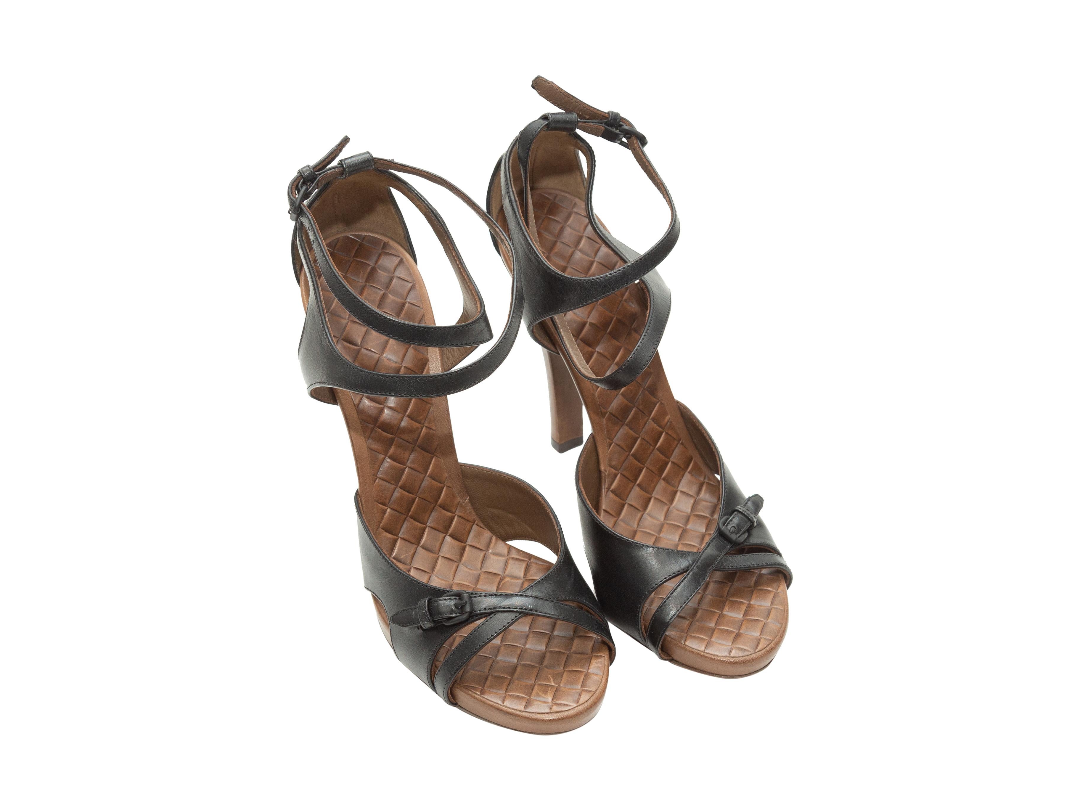Product details: Black leather heeled sandals by Bottega Veneta. Intrecciatio insoles. Brown covered leather heels. Buckle closures at ankle straps. Designer size 39. 4.5