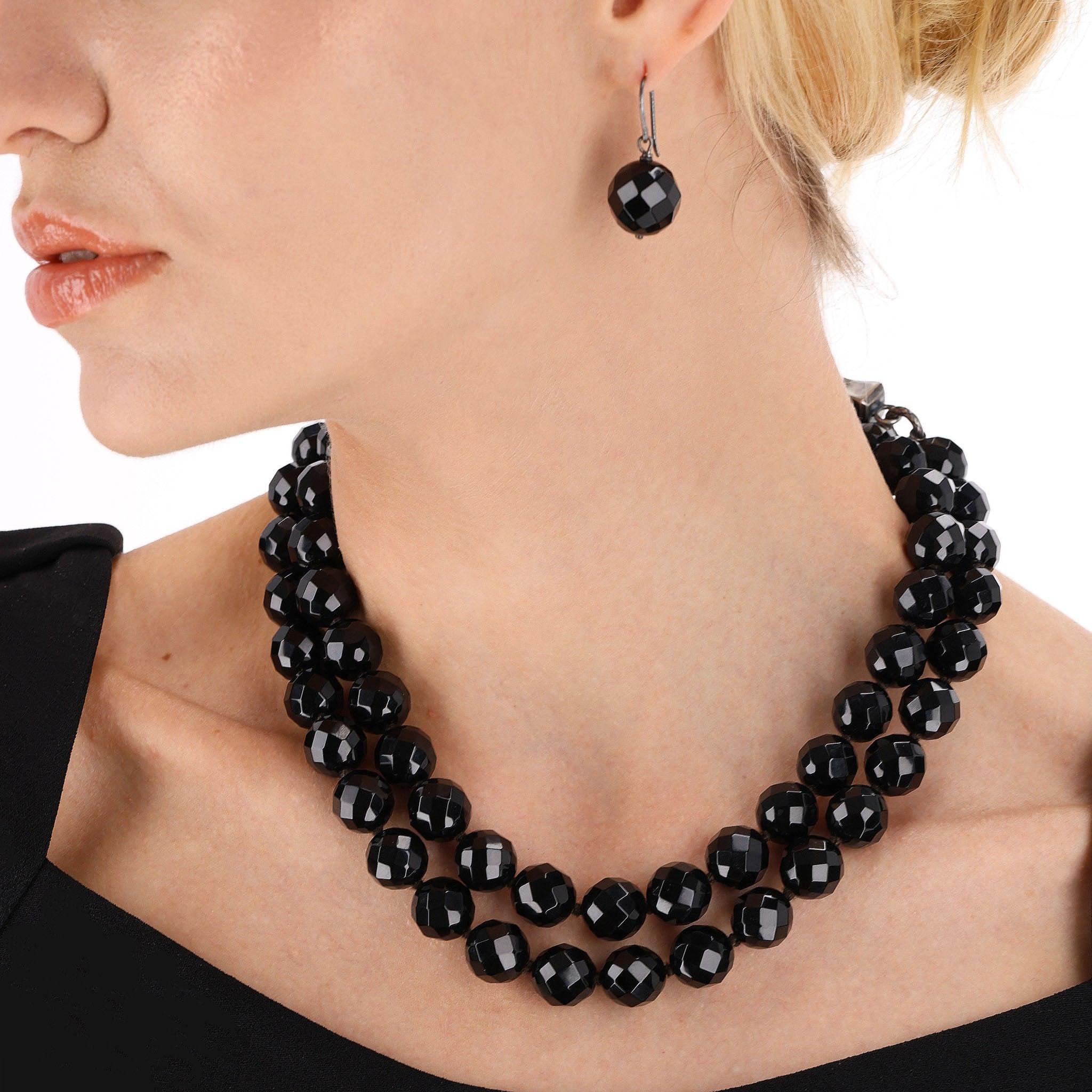 Bottega Veneta Black Onyx Beaded Necklace & Matching Earrings Set

Black shiny faceted onyx stone set of dangle earrings and matching necklace with oxidised sterling silver closure and settings.

The necklace is long and can be worn doubled if