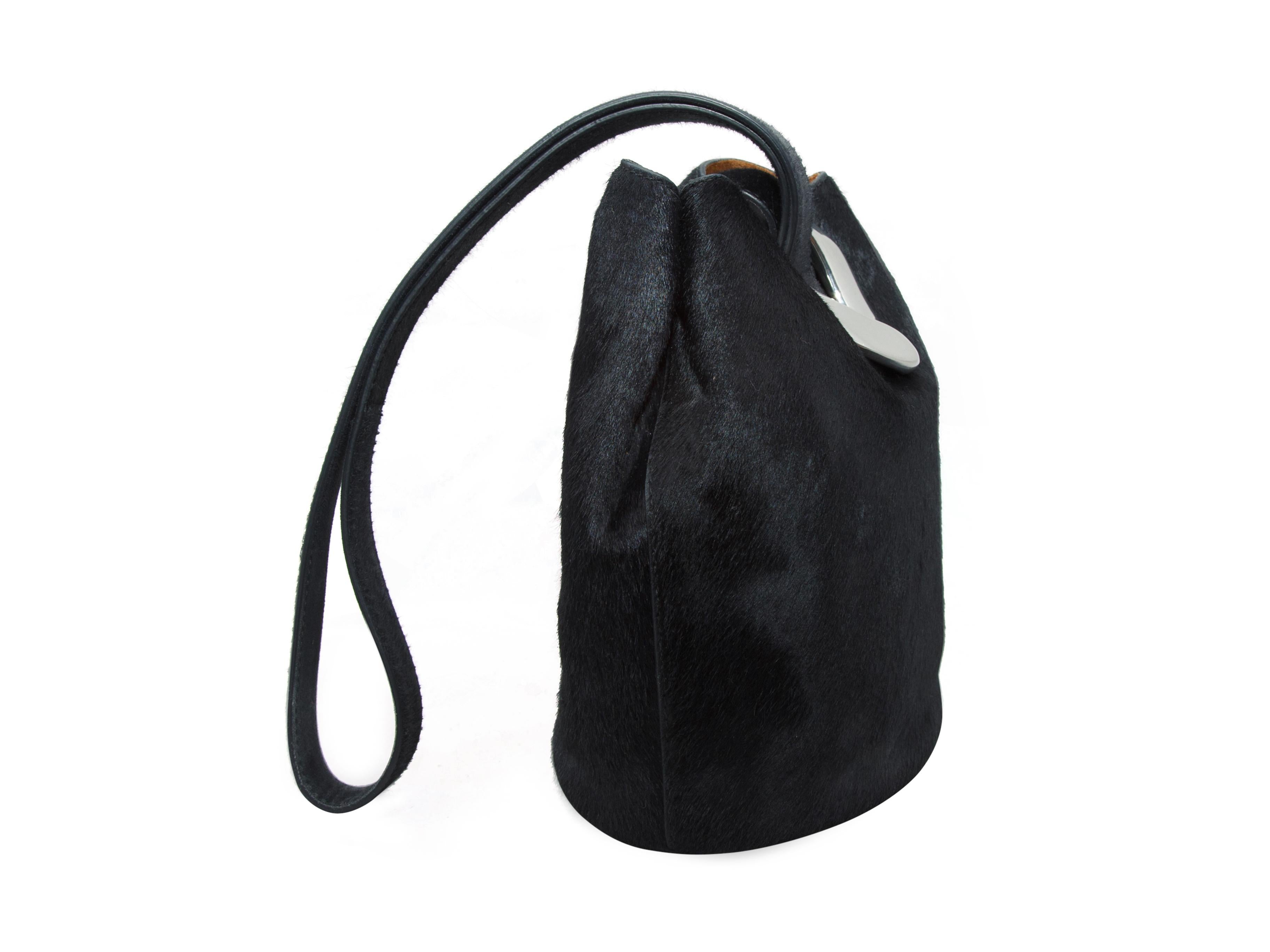 Product details: Black ponyhair bucket bag by Bottega Veneta.  Single shoulder strap.  Concealed double magnetic closures.  Lined interior with inner slide pocket.  Silvertone hardware.  Dust bag included.  7