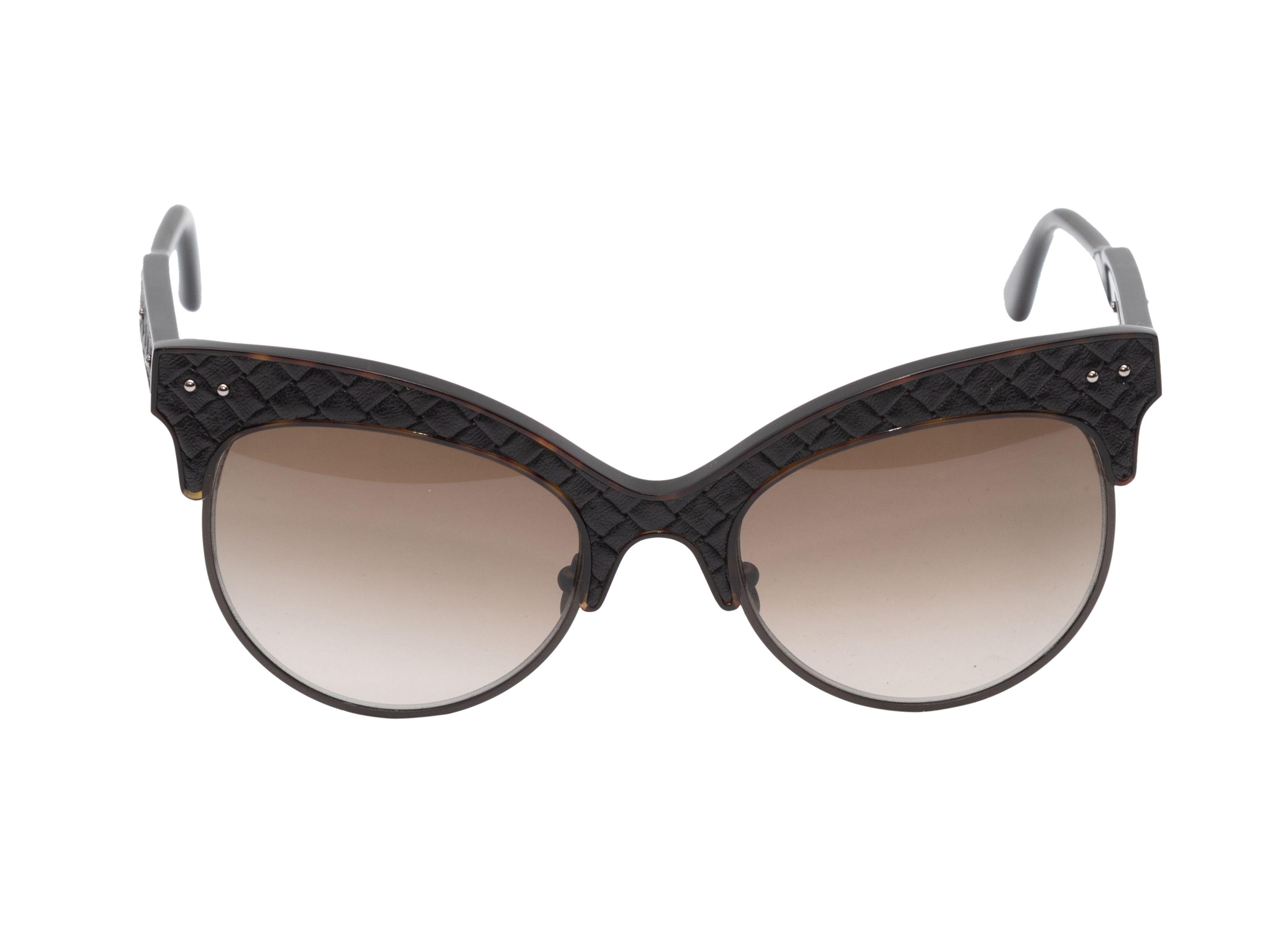 Product Details: Black quilted acetate cat-eye sunglasses by Bottega Veneta. Brown tinted lenses. 2