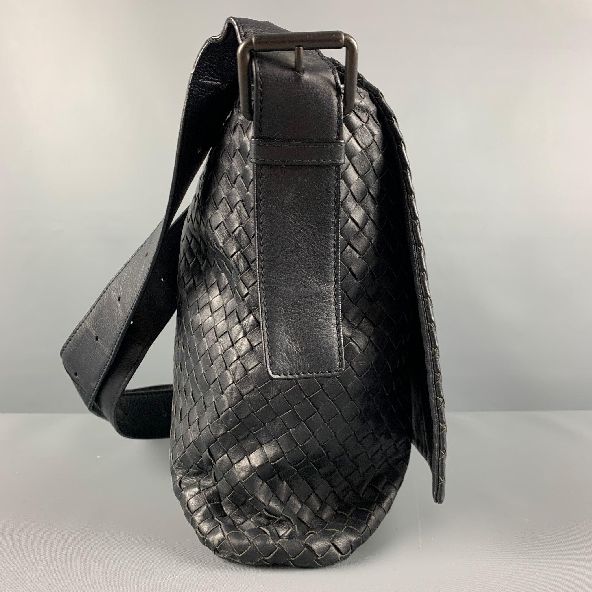BOTTEGA VENETA bag comes in a black leather featuring a messenger style, adjustable crossbody strap, front flap, and inner pockets. Very Good Pre-Owned Condition. 

Marked:   B018718850 

Measurements: 
  Length: 16 inches Width: 3.75 inches Height: