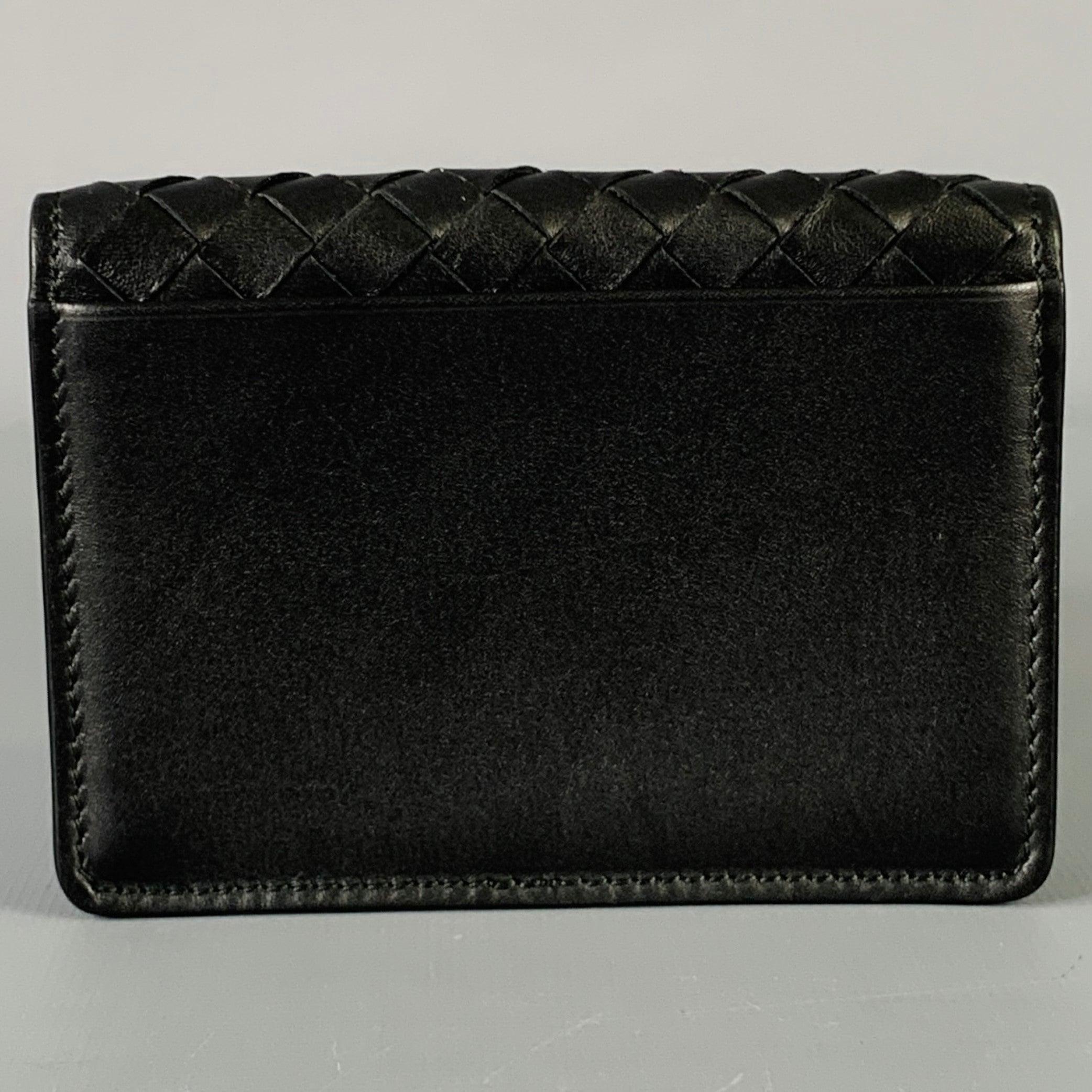 BOTTEGA VENETA wallet
in a black leather featuring a woven style, flap opening, and card slots inside and on the back of the wallet. Comes with box, dustbag, and brand card. Made in Italy.Excellent Pre-Owned Condition. 

Marked:   B05659360D4.25 x 3