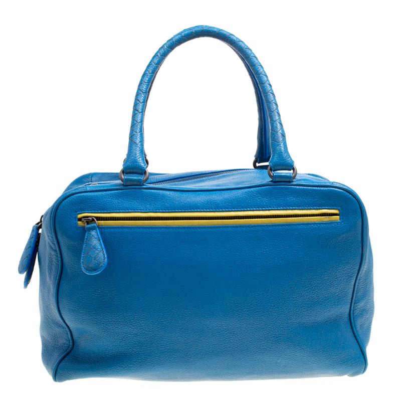 That gorgeous dress of yours needs the perfect accessory and what better than this Madras Heritage Brera bowler bag from Bottega Veneta. Charming in blue, this bag is crafted from leather and features a chic silhouette with a zipper pocket at the
