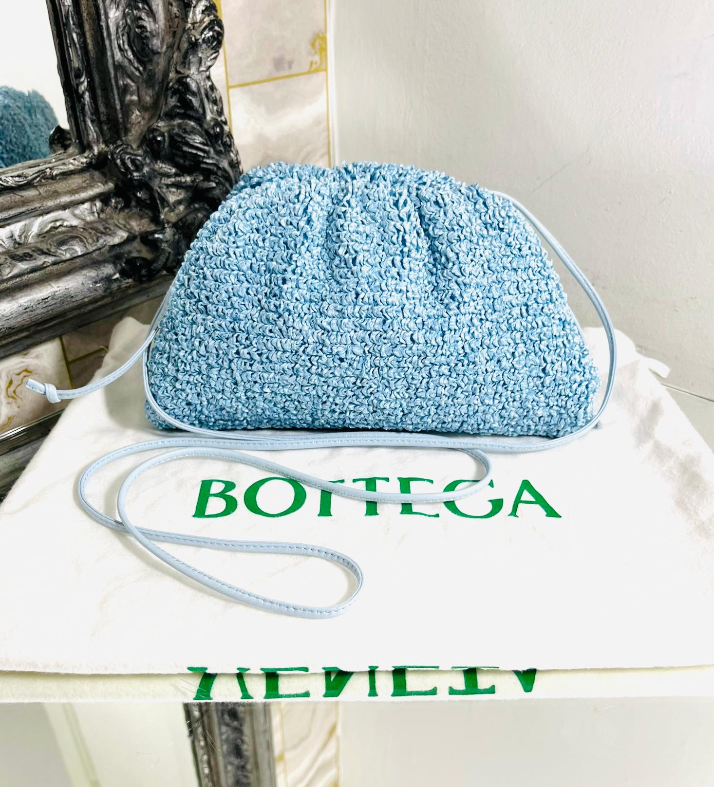 Bottega Veneta Boucle Curly Raffia The Mini Pouch Bag

Light blue crossbody bag designed with textural exterior.

Featuring magnetic top closure leading to white leather interior.

Detailed with thin, leather crossbody strap accented with the