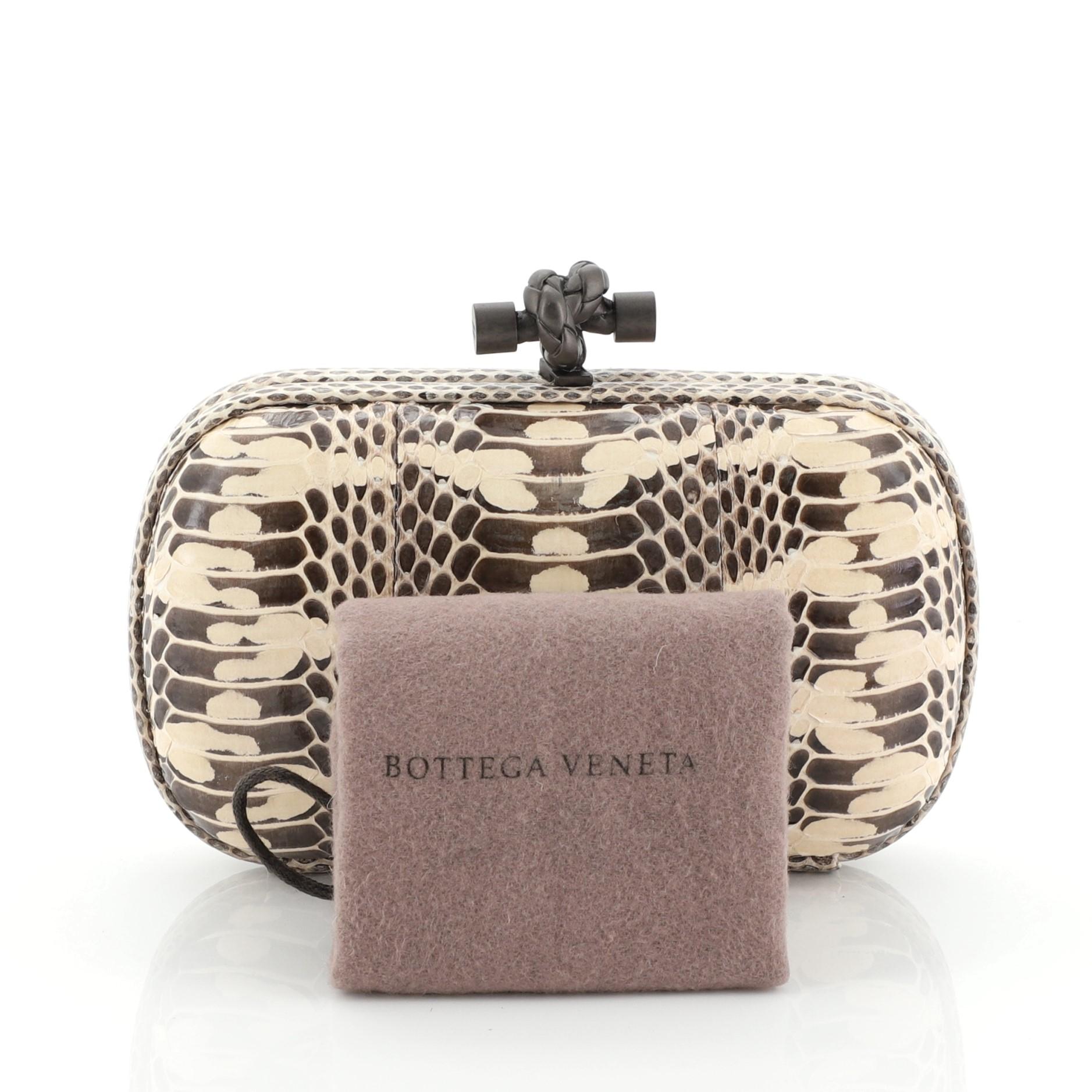 This Bottega Veneta Box Knot Clutch Python Small, crafted from genuine multicolour python features python frame trims and matte gunmetal-tone hardware. Its top knot clasp closure opens to a neutral leather interior. This item can only be shipped
